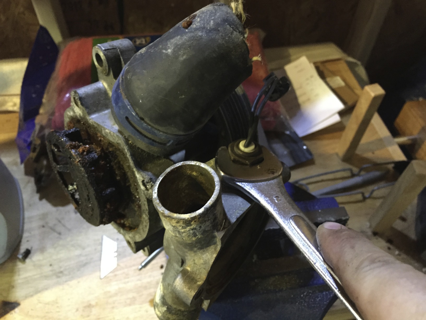 Removing the coolant temperature sensor with a 19mm socket.