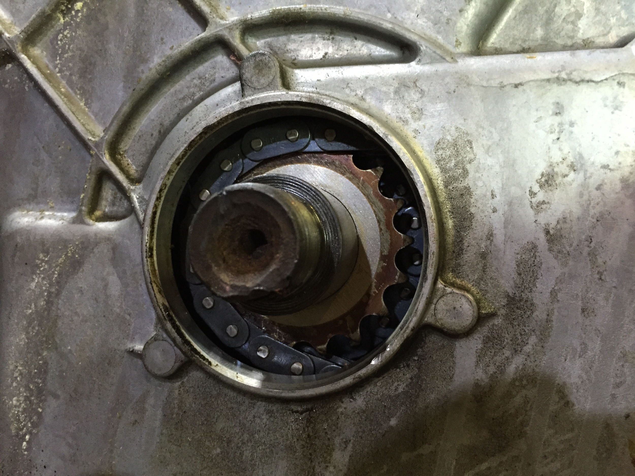 The installed timing cover with the front main seal removed. The seal seals against the main pulley, not against the crank itself.