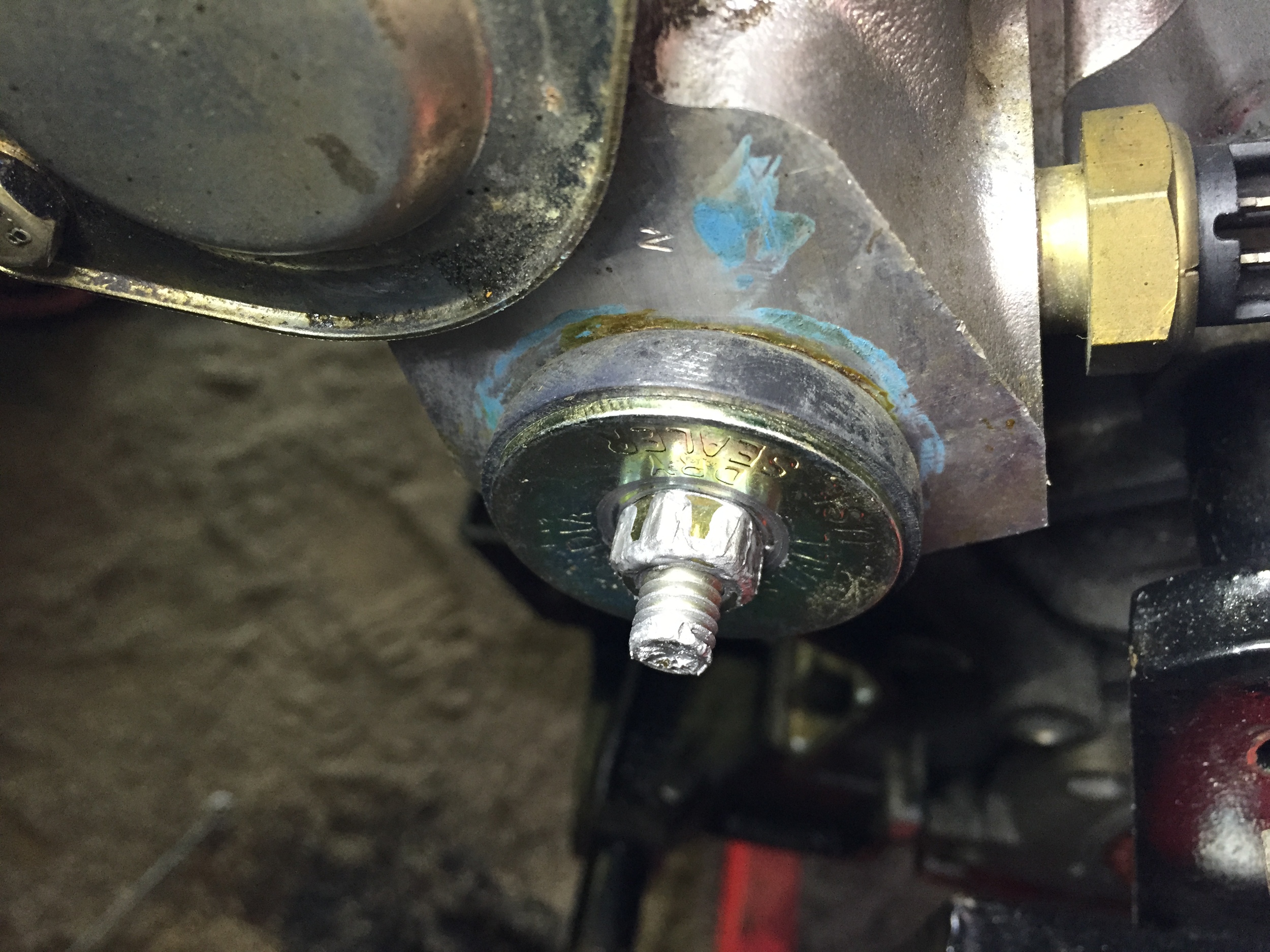 The rubber core plug installed in the head, its threads lathered with anti-seize to ease removal in the future.