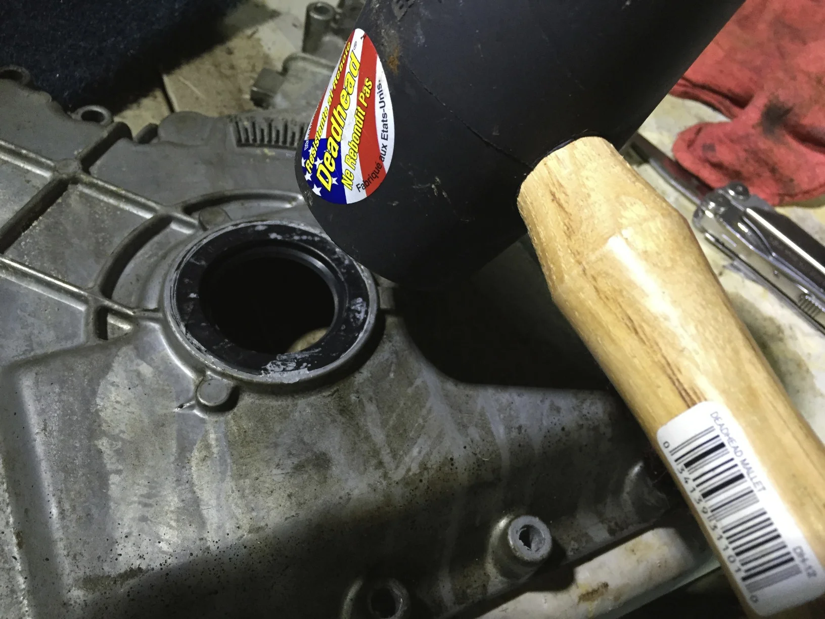 Seating the new seal with a rubber mallet.