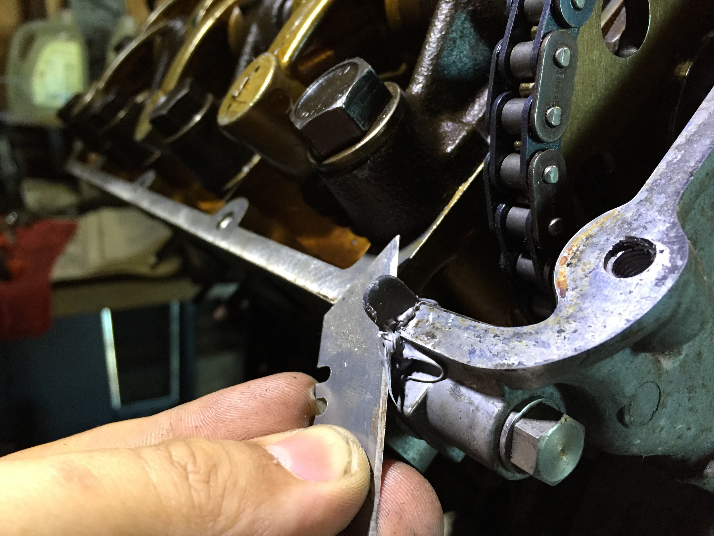 Cutting off one of the tabs on the end of the lower timing cover gasket before installing the valve cover gasket.