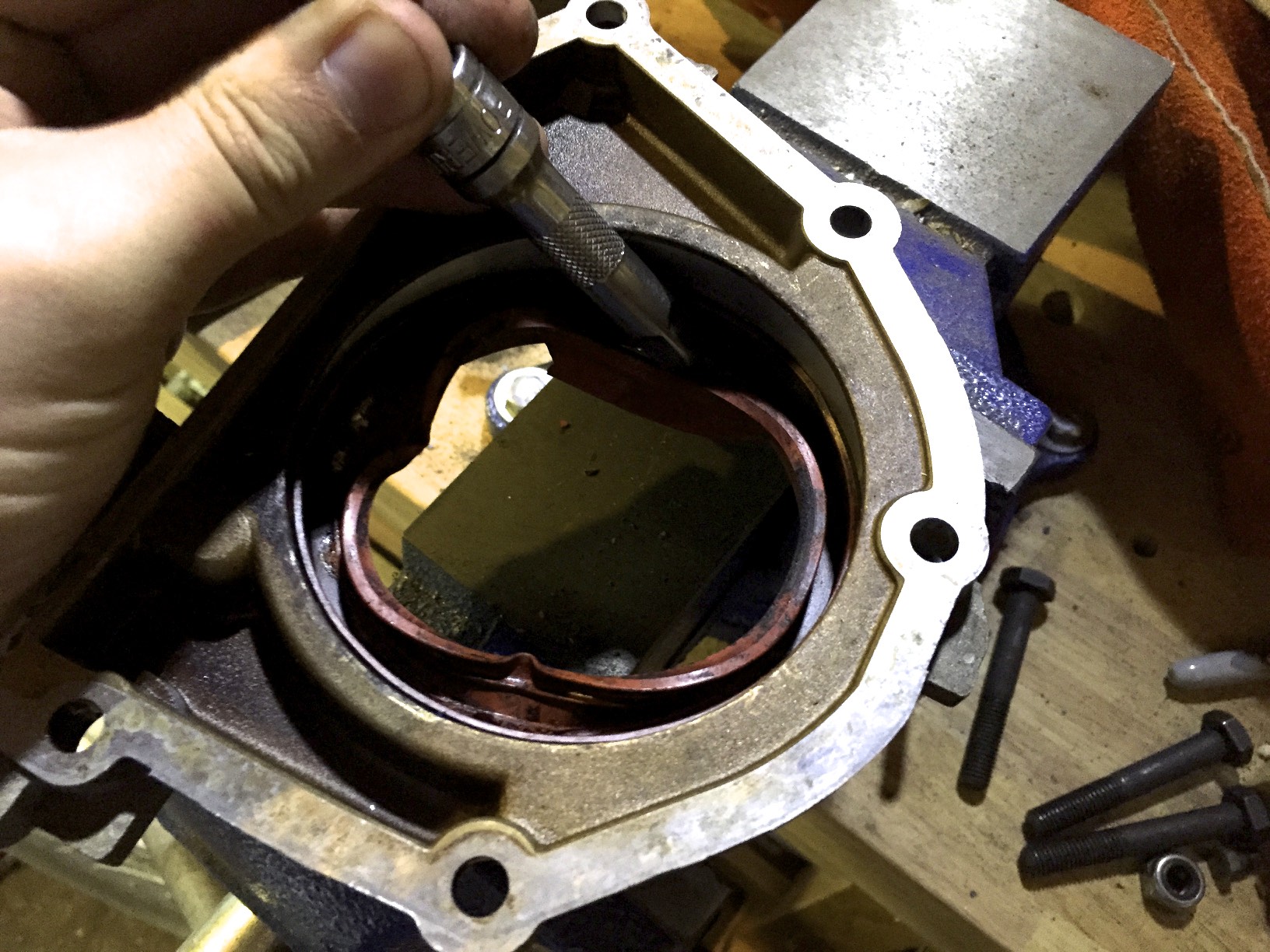 Positioning a socket extensions to tap the old seal out with a hammer. You can see the damaged done to the seal from tapping it out on the opposite side.