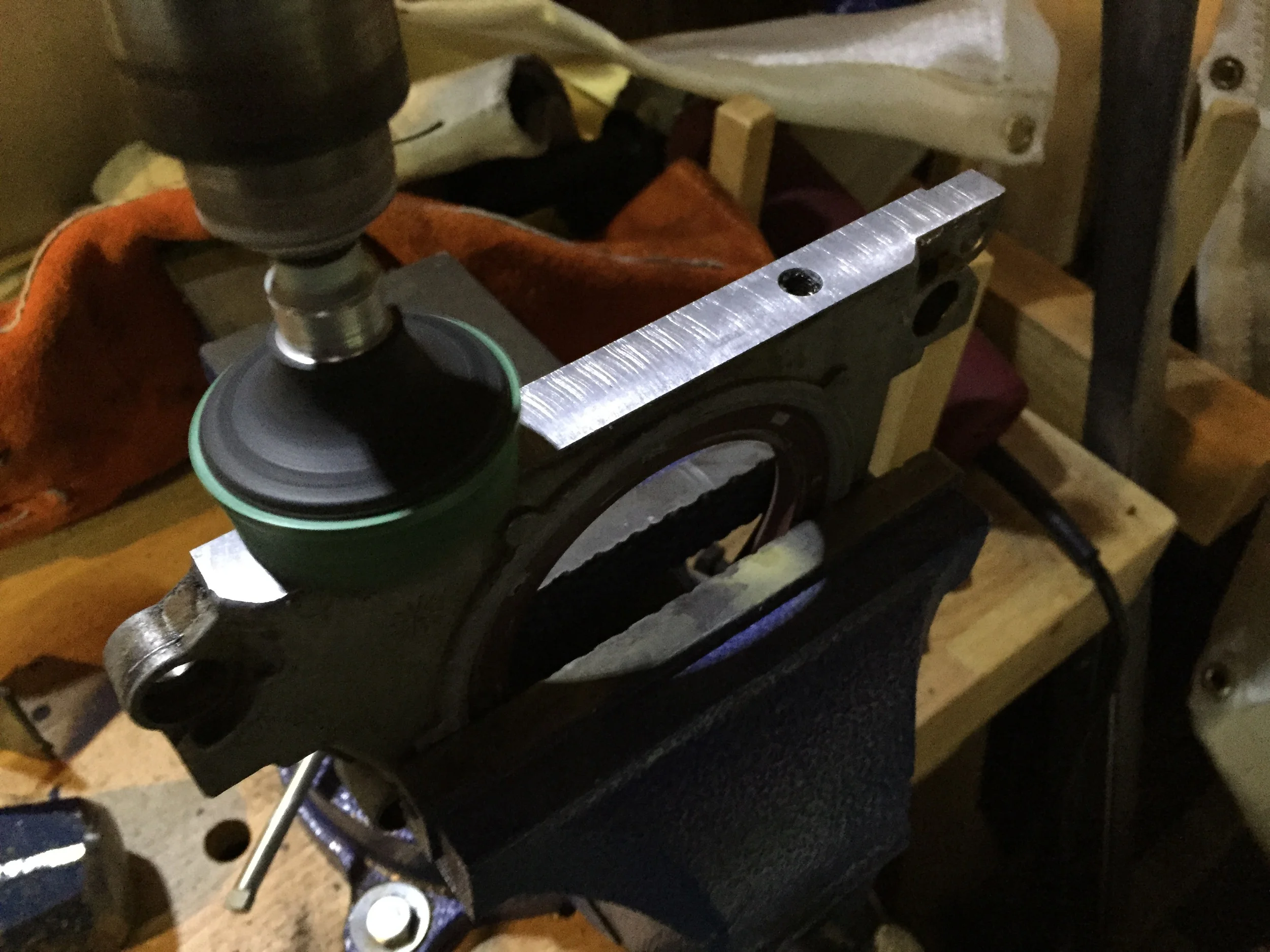Using a bristle disc on a power drill to clean the horizontal surface of the plate.
