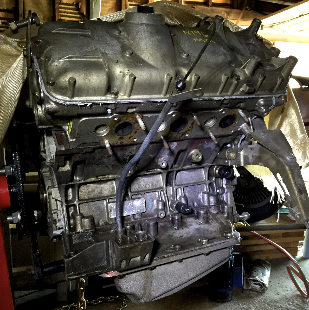 The engine dipstick reinstalled in the lower crankcase.