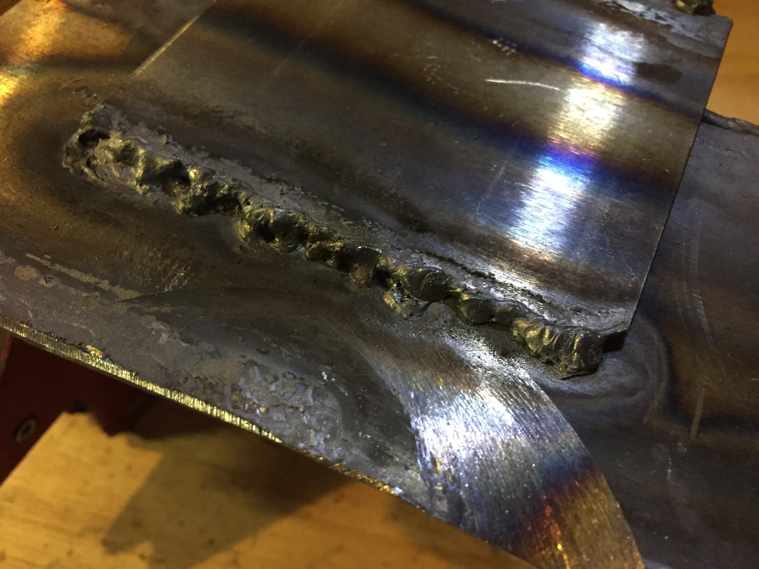 An attempt with my friend's auto-dimming welding helmet. Combined with other problems with the cleanliness of the metal itself, the helmet was meant for electrical welding, and only dimmed to 9 -- oxyfuel welding uses lenses of 4 or 5.