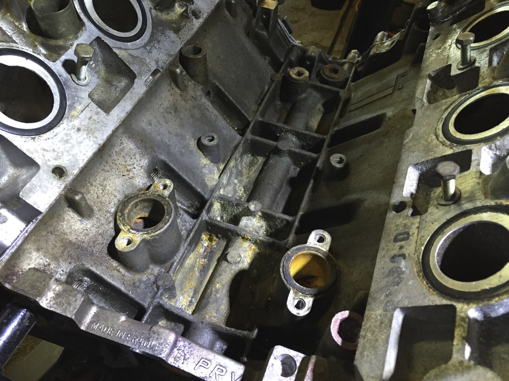 Looking towards the front of the engine, the two smaller holes at the bottom of the picture are where the "Y" pipe mounts to the block. The old O-rings are still sitting in their recesses.