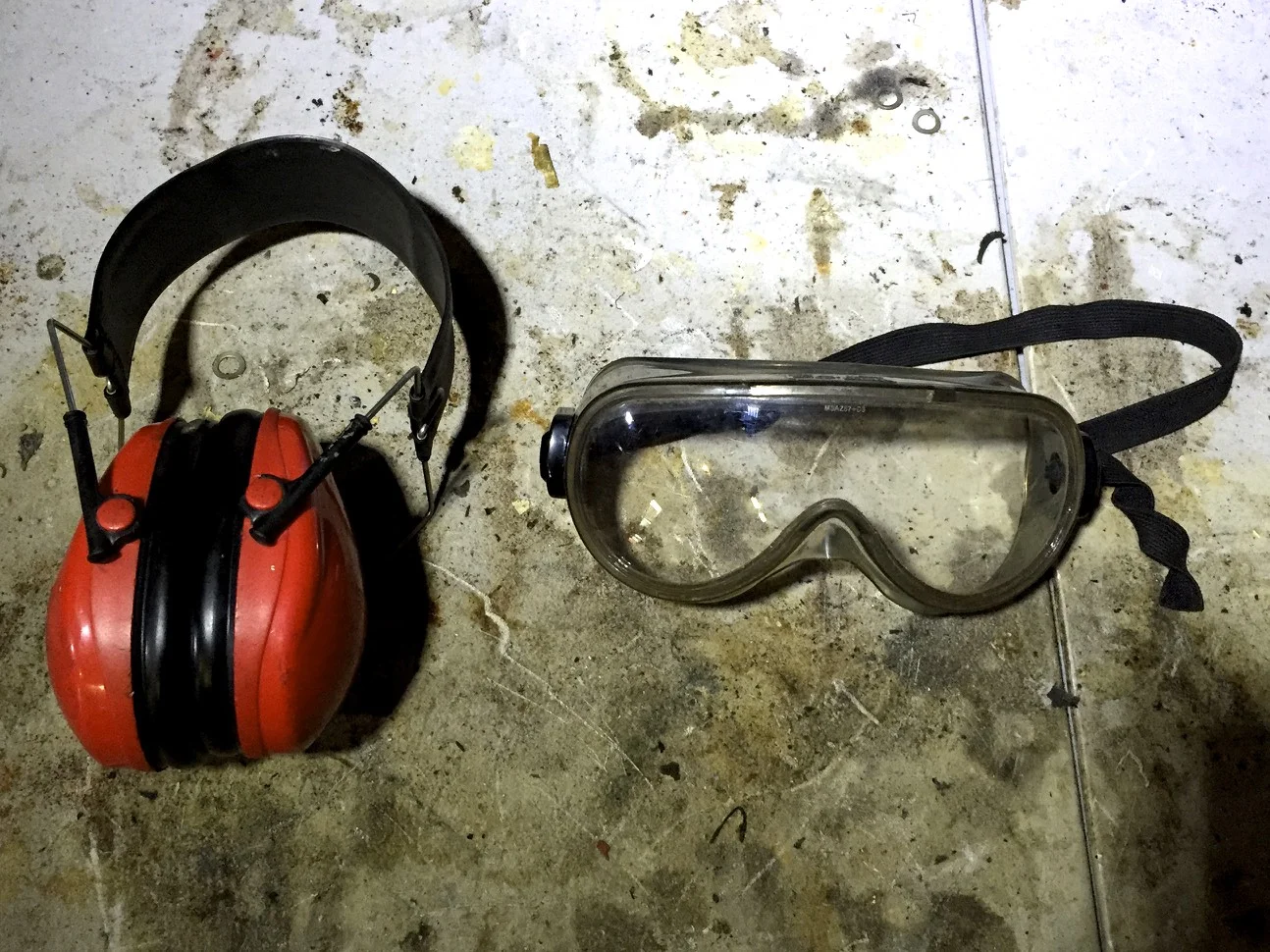 Muff-style hearing protectors and safety goggles.