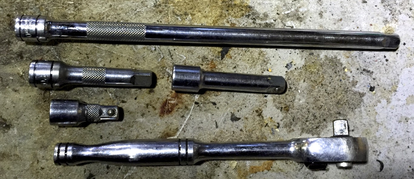 Various length of socket extensions and a socket wrench.