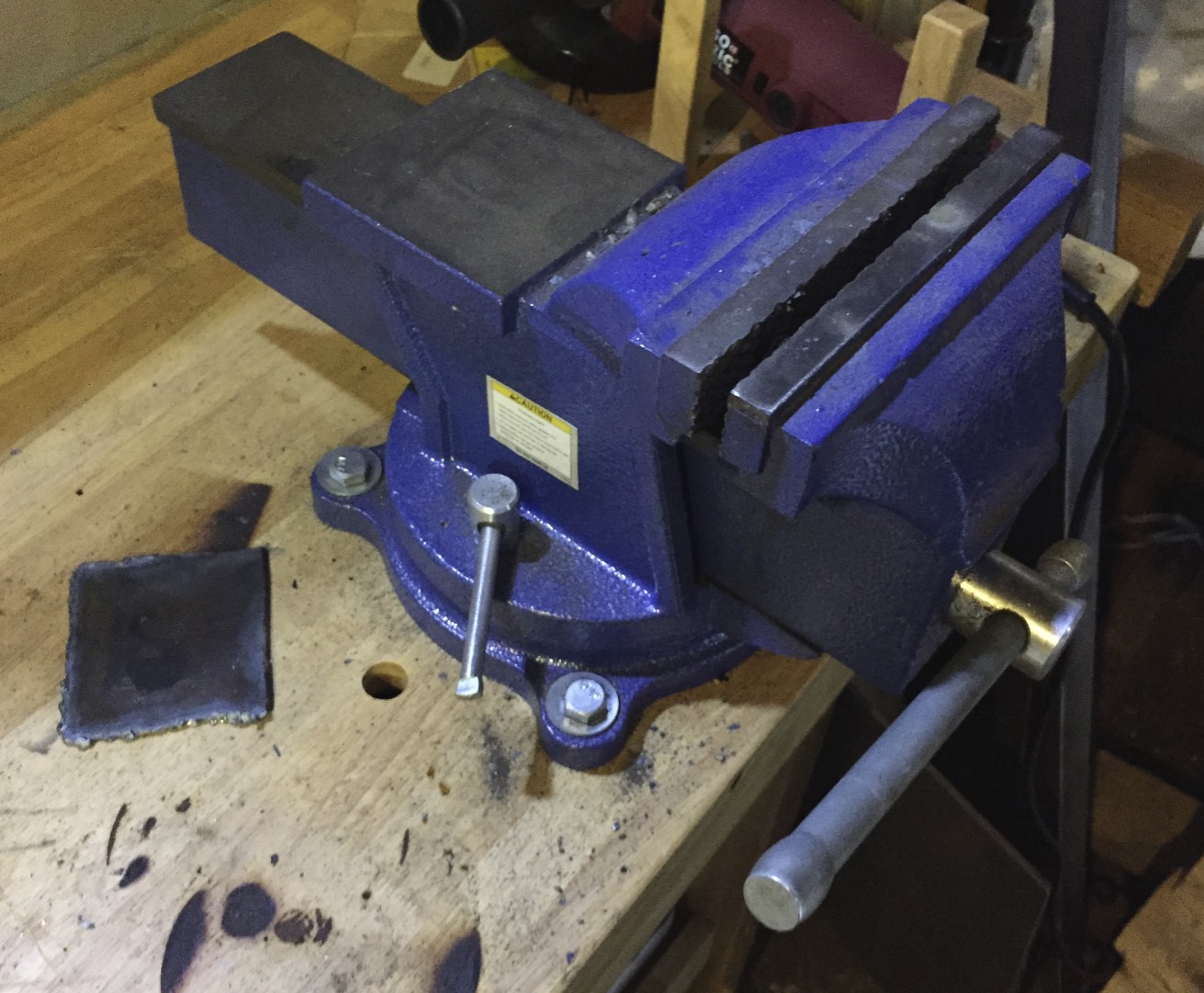 A bolted-down bench vice.