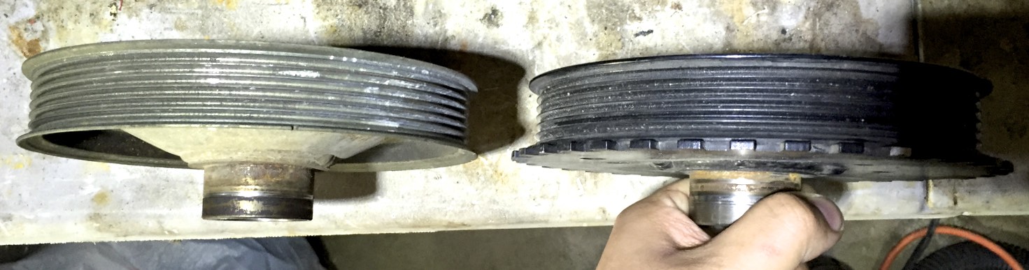 The original (left) and modified (right) pulleys. Notice that the bowl-like shape was machined away so that the gear could sit flush with the widest part of the pulley.