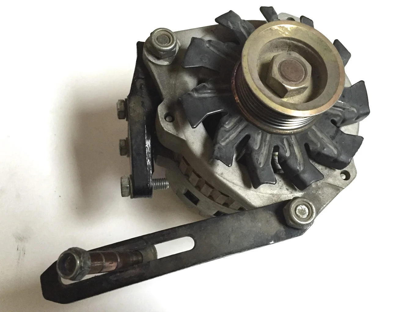 The new alternator with the mounting and adjustment brackets.