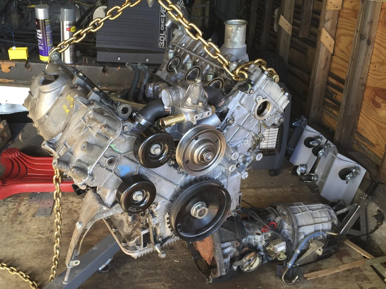 Swinging the engine around on the hoist to get mate it with the transmission.