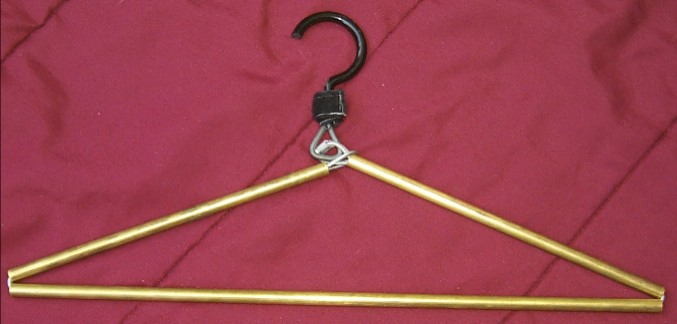 Normal state when being used. The hanger end loop slides along the brass pipe to collapse and expand the hanger.