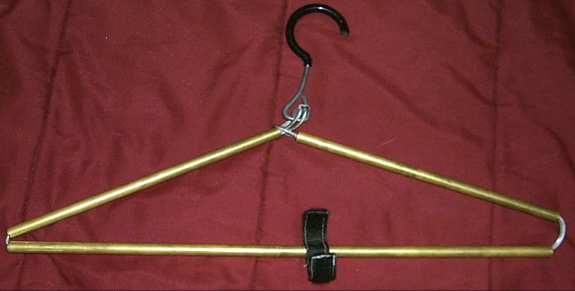 The new design expanded. The bottom bar is now two separate pieces that slide together. The velcro strip around has been made longer and moved to a more central location around the rods instead of on the hanger.