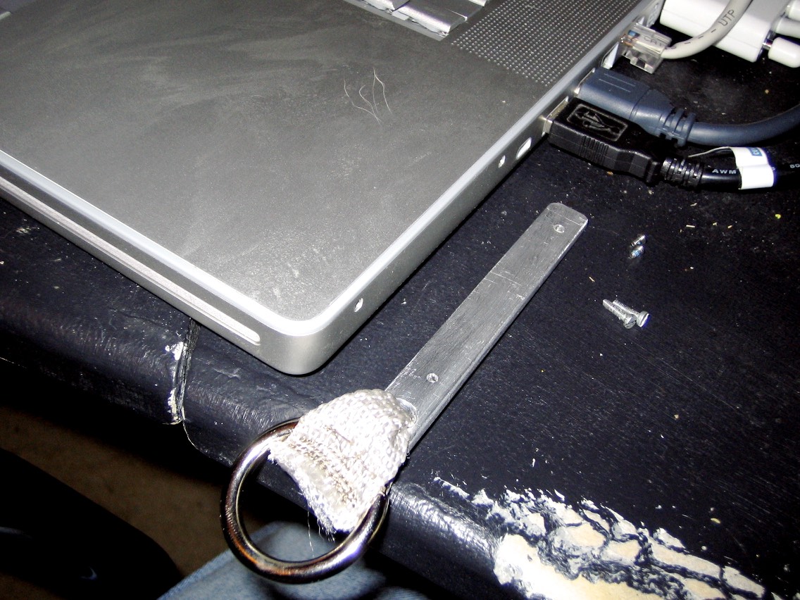 The strap mount before attaching it to the laptop.