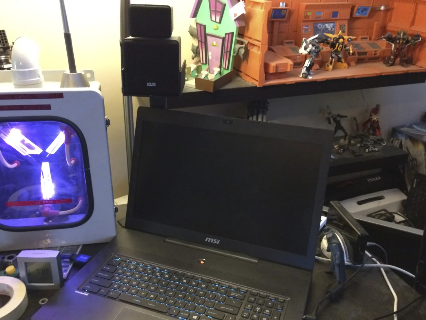 The rear left speaker stand sits behind my Windows laptop's monitor. The heigh tot the stands was chosen specifically to clear its display.