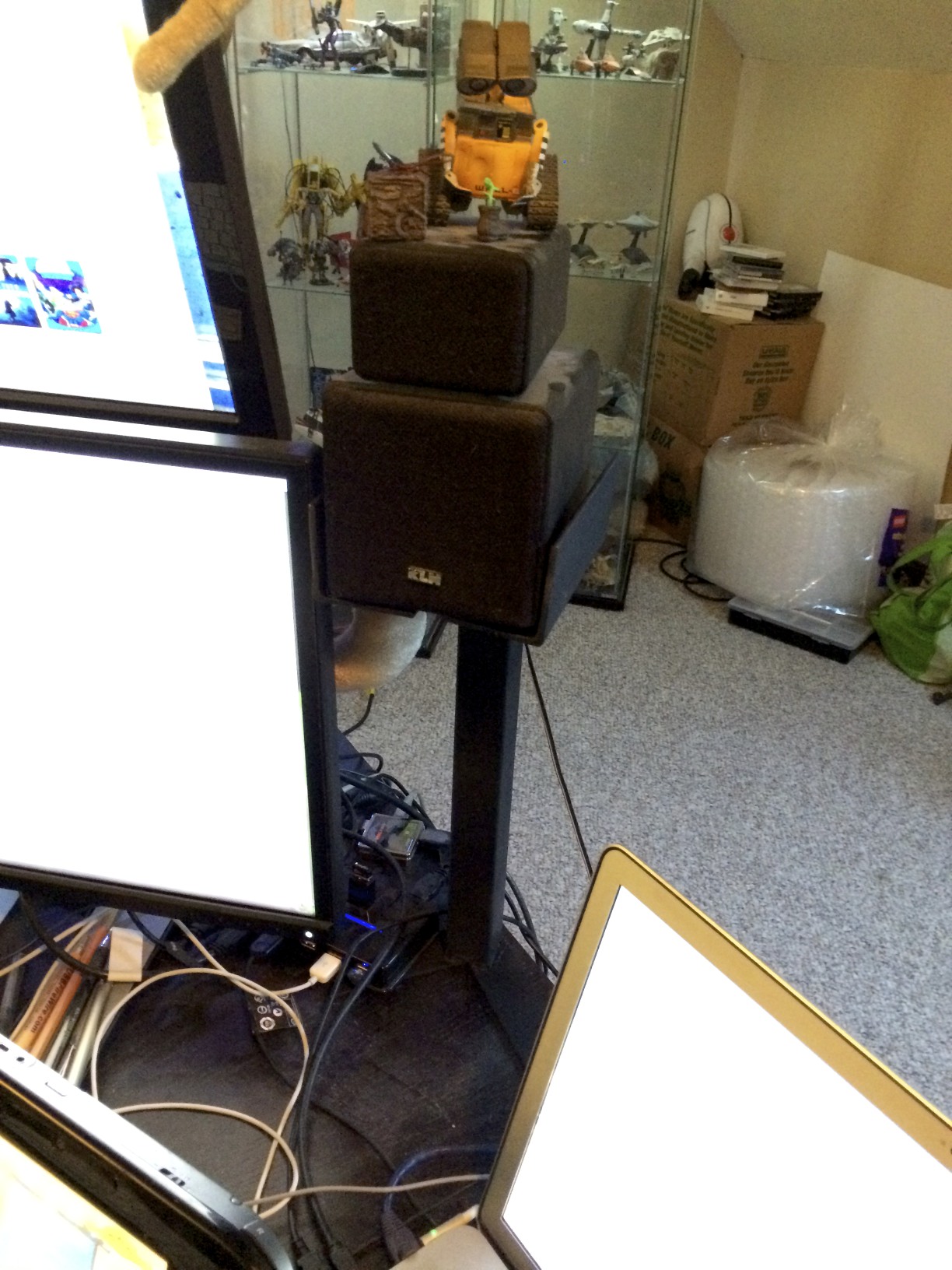 The right speaker stand sits between the stacked monitors and my MacBook Pro.