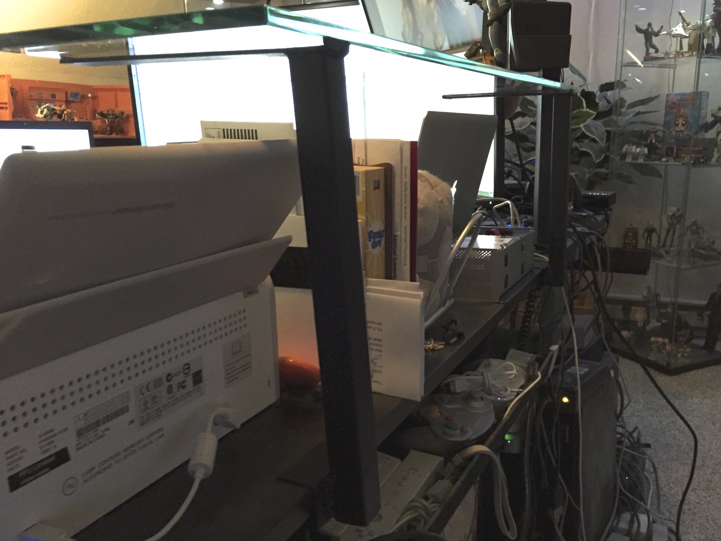 The mounts attached to the desk with the shelf resting on it.