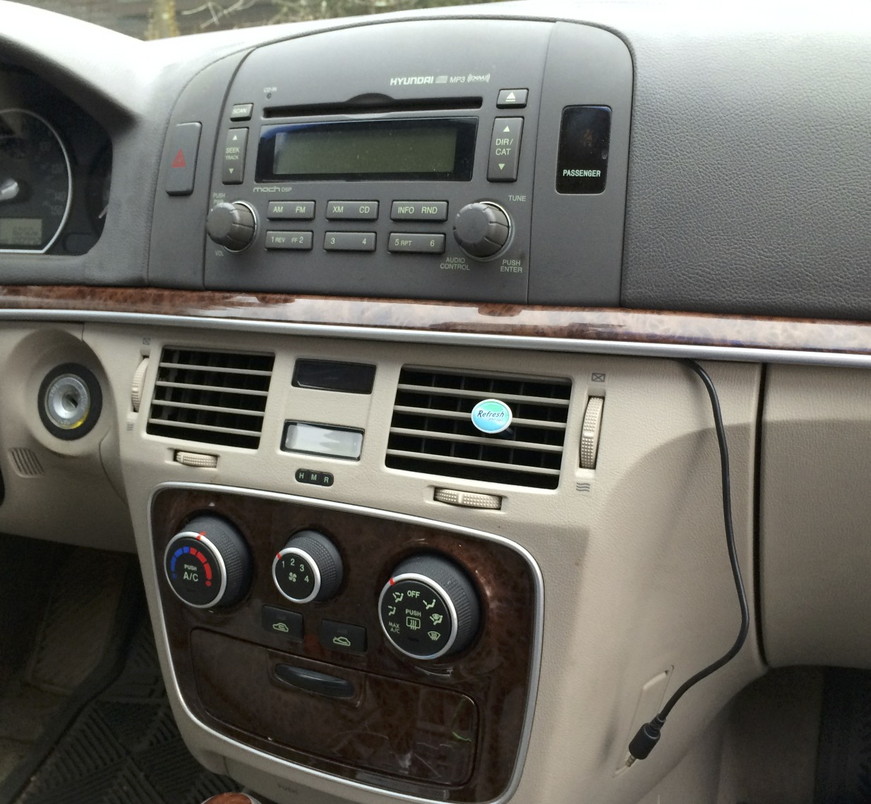 Final installation, with the headphone wire running out from under the dash.