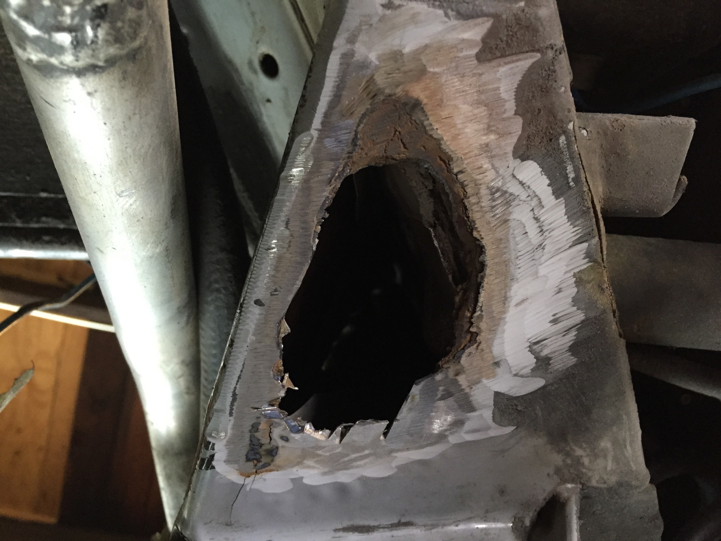 The cleaned up hole under the driver's side engine cradle.