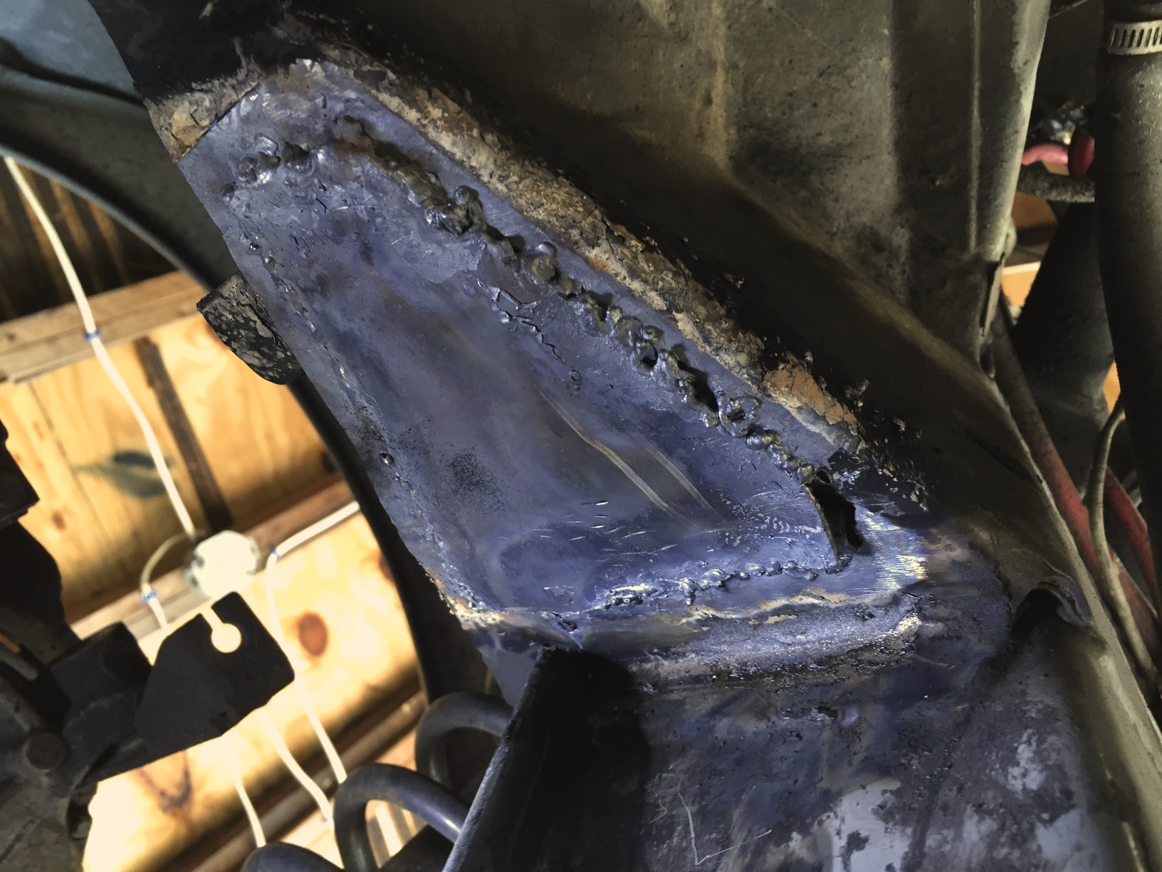 The patch mostly welded into place. While the weld is decently strong, the right edge is obviously very poor quality.