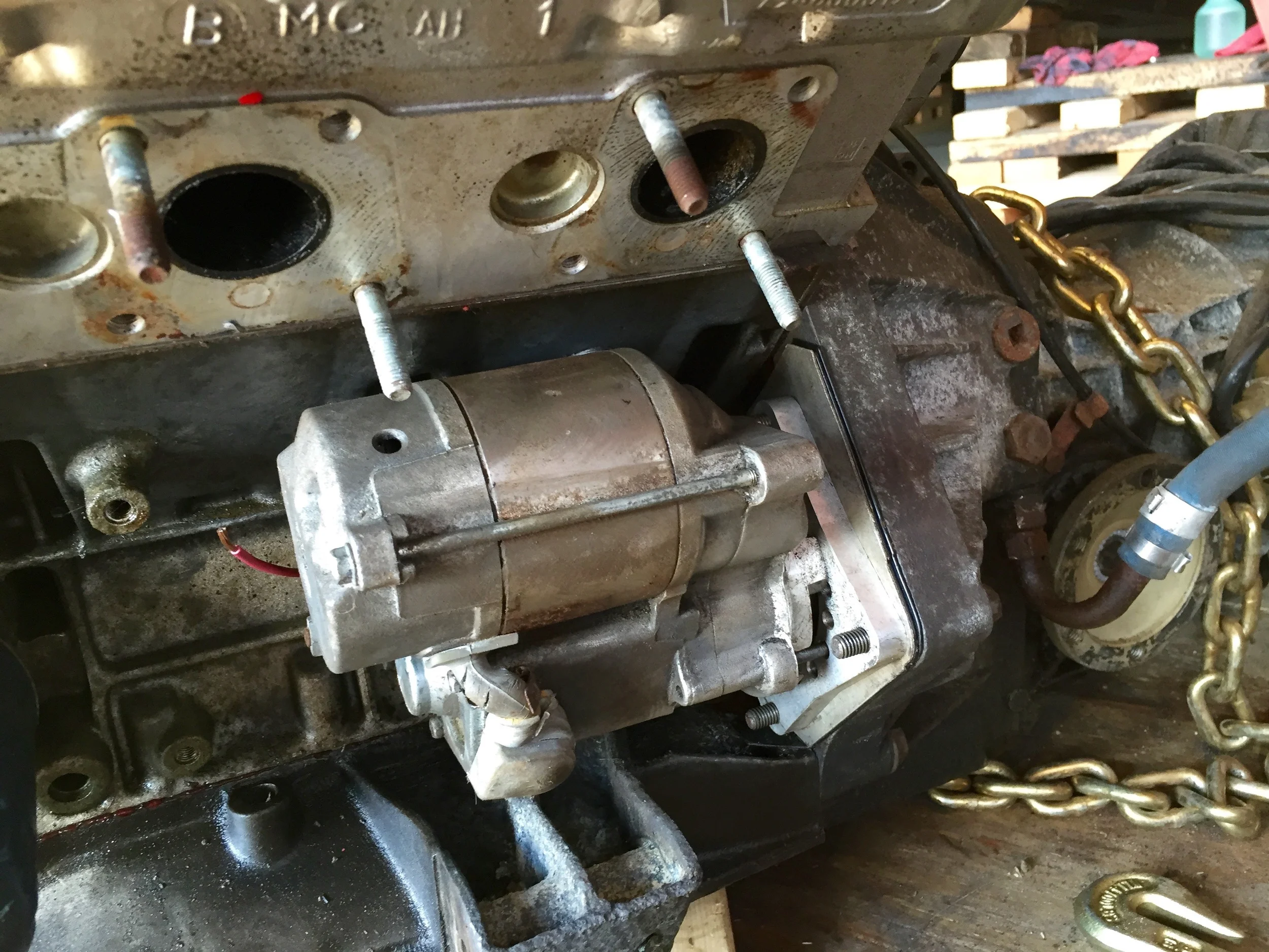 The starter bolted to the transmission bell housing.