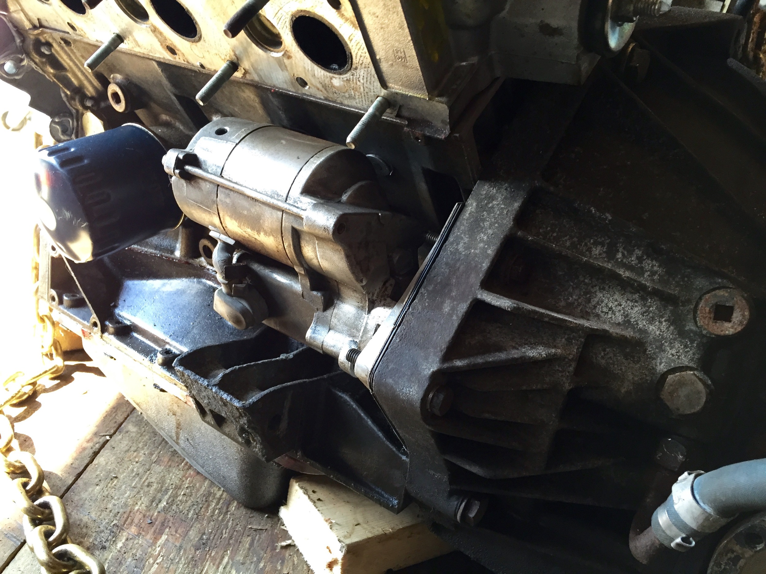 Three bolts holt the starter in place, and are tightened with a 13mm socket.