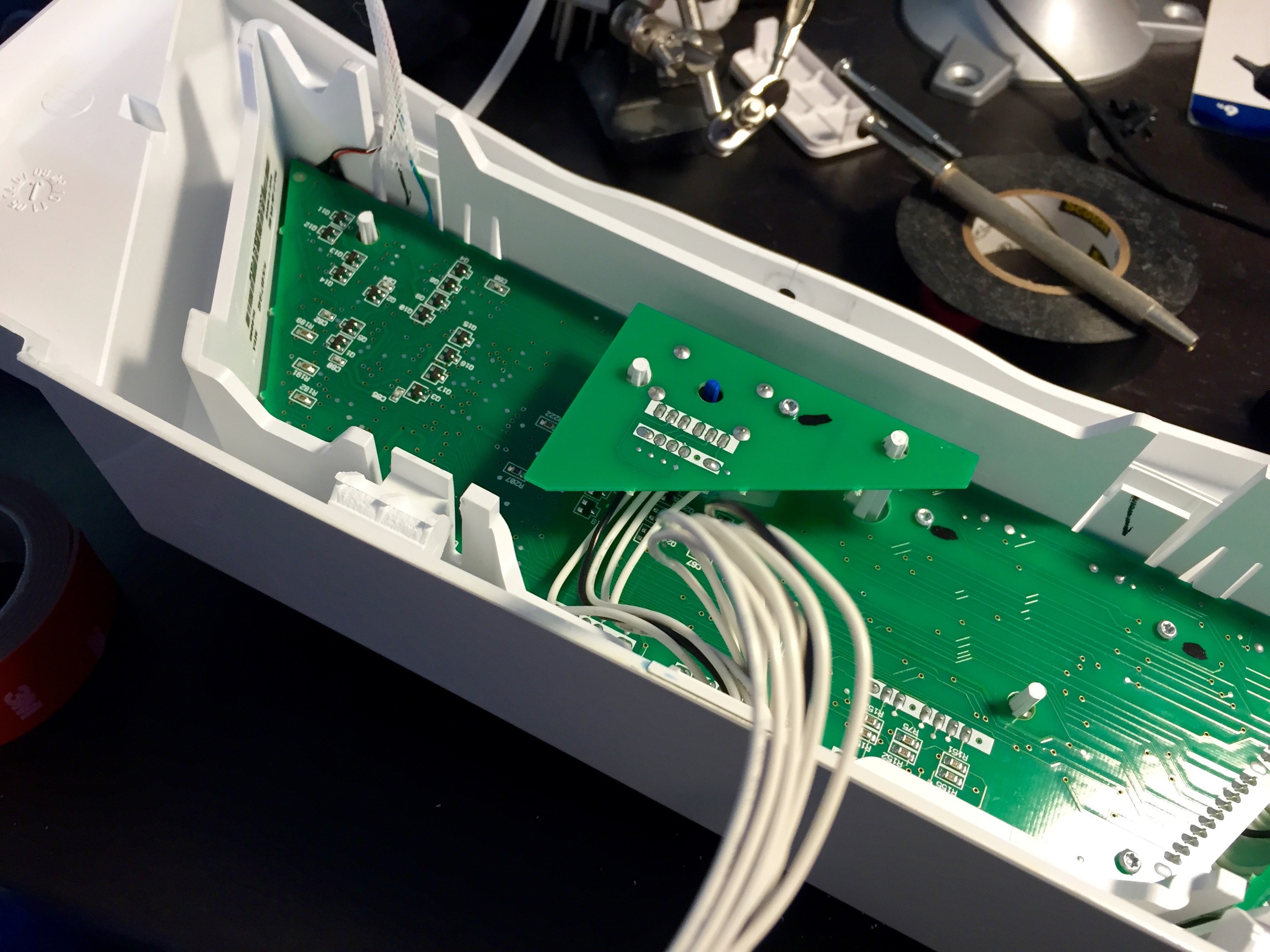 The board reassembled into the case. The white sheathing can be seeb coming out of the top left corner.
