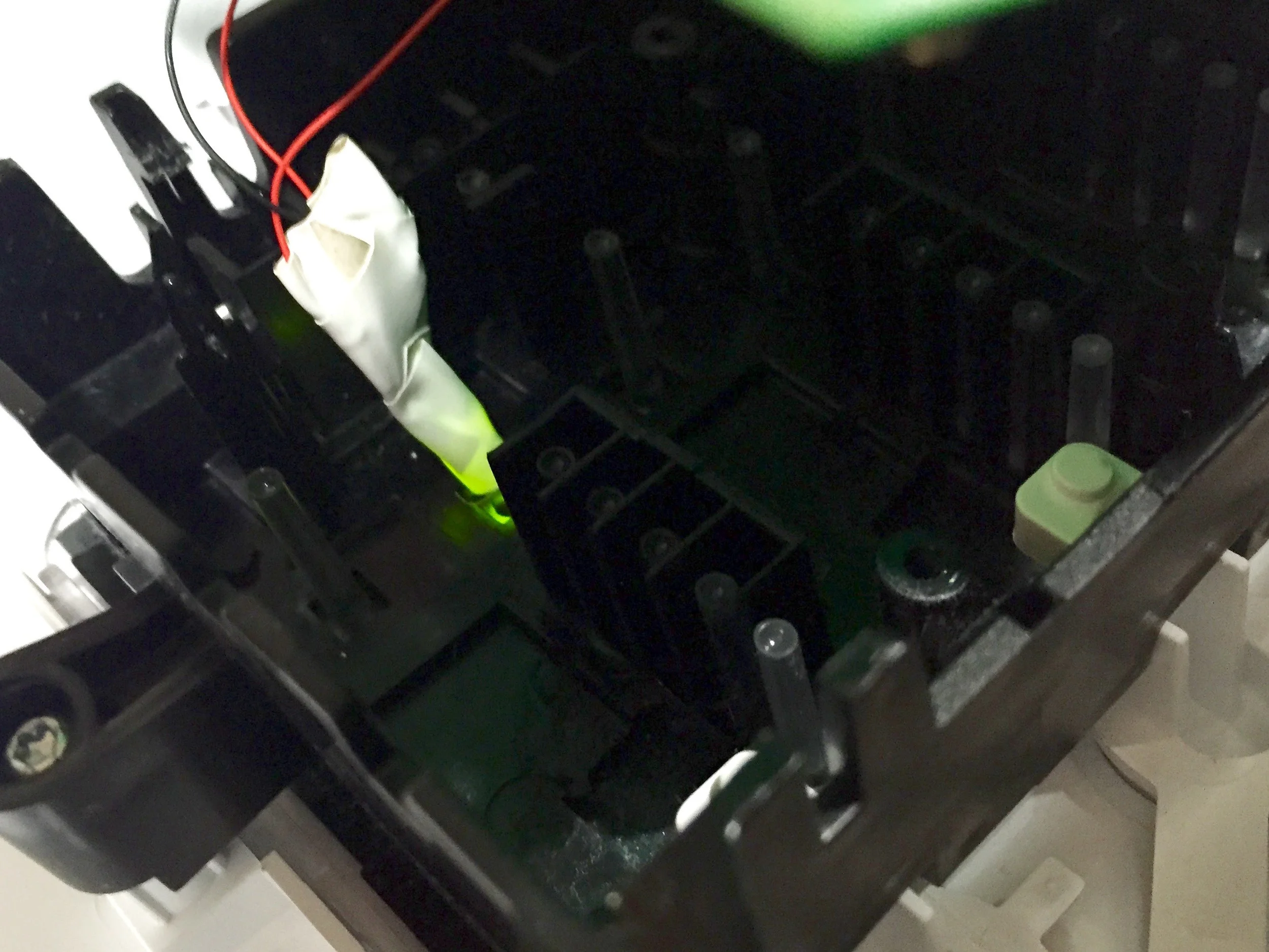 Revised LED placement. I snapped off the acrylic post (you can see others on either side for the other LEDs) and taped my LED so that it pointed along it