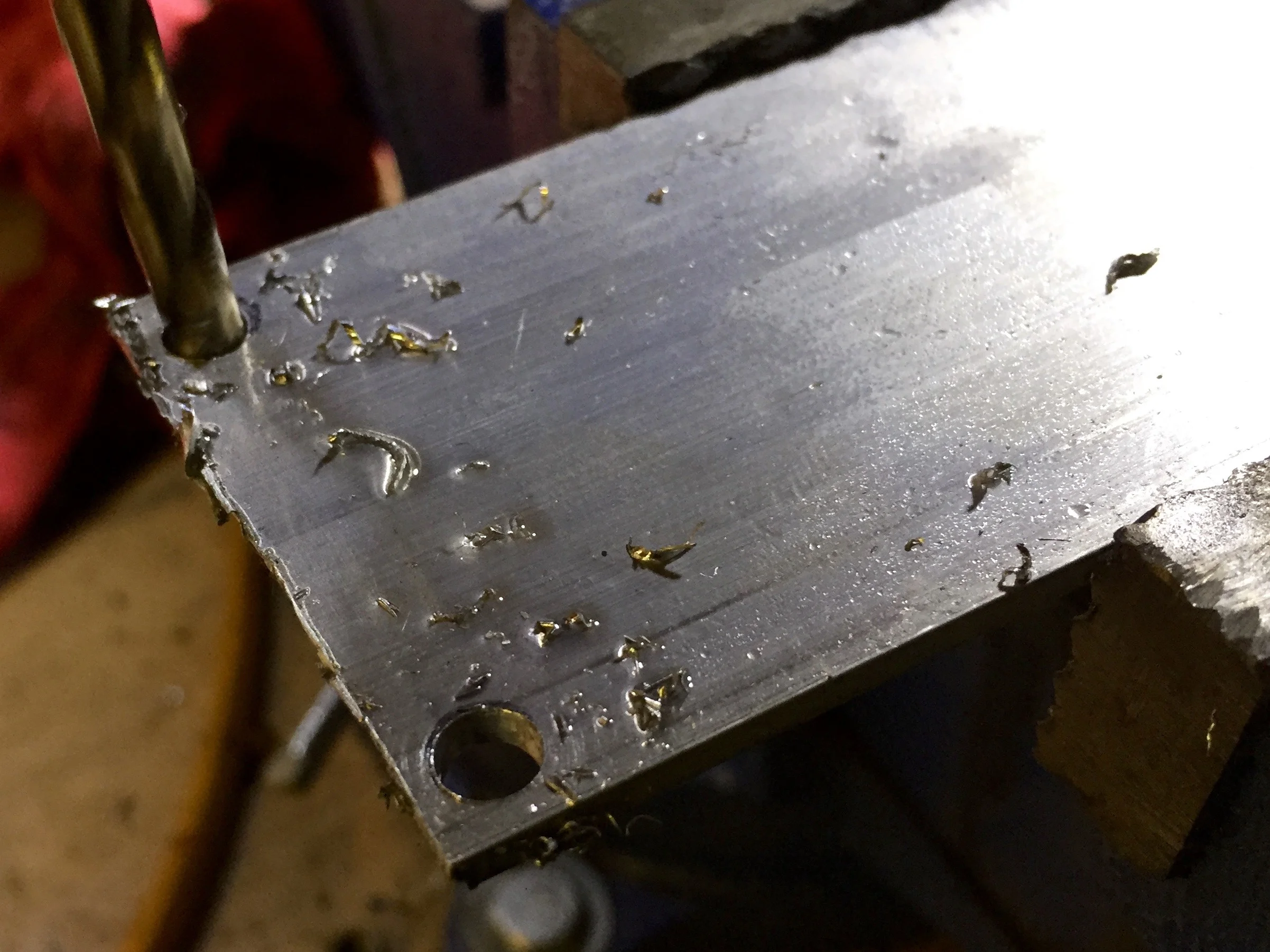 Drilling holes into my aluminum stock for the backing to replace the nuts fro the transmission cable bracket.