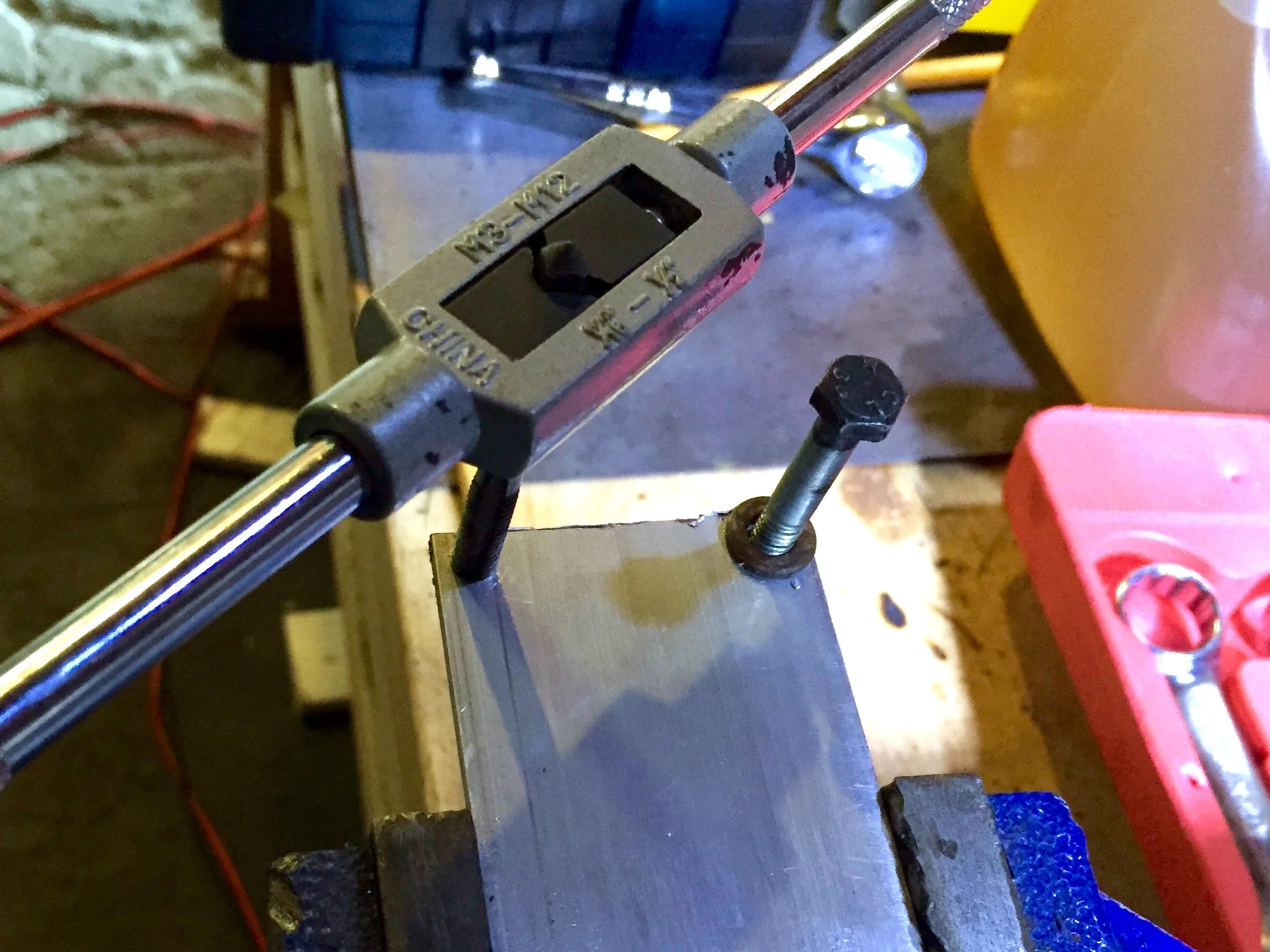 Tapping new holes into the backing.
