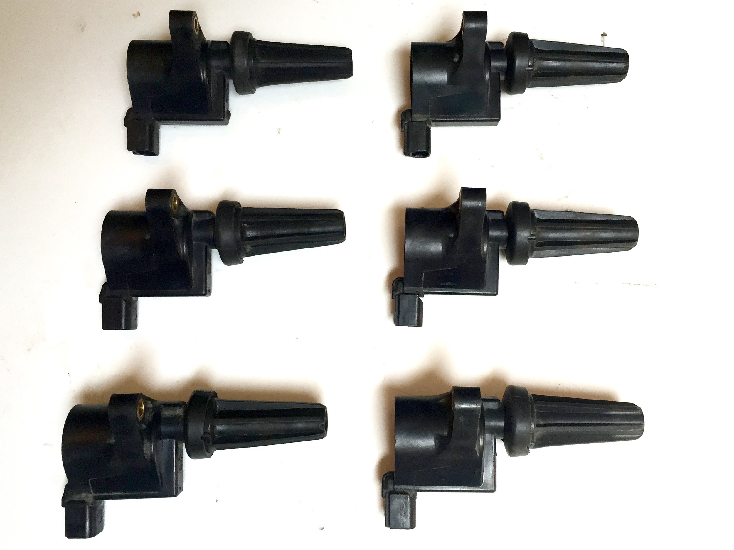 Six coils mounted onto the 3.0L engine's original spark plug wire heads.
