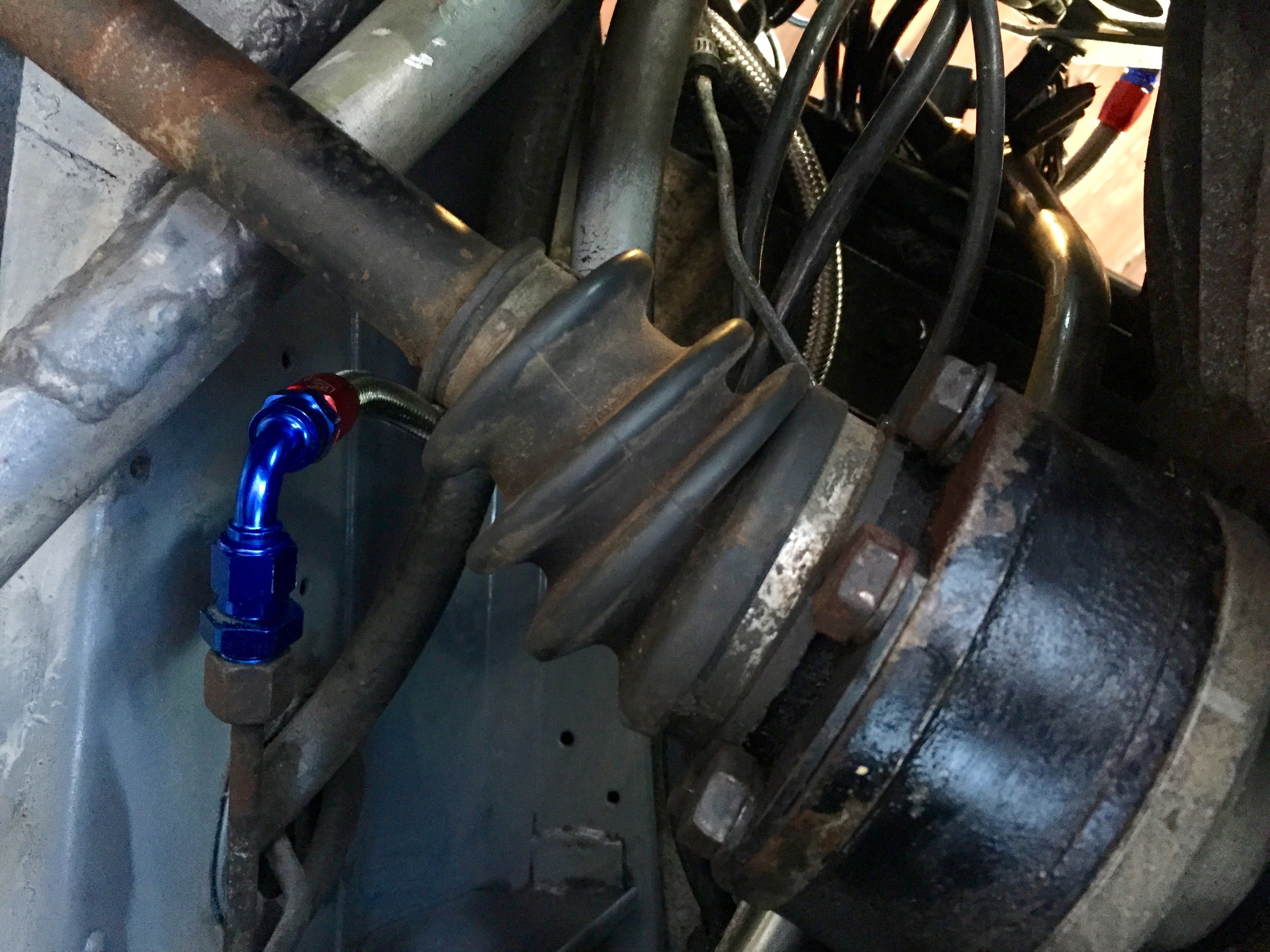 The fuel line under the car, where a 90 degree AN-6 adaptor runs up to the fuel filter.