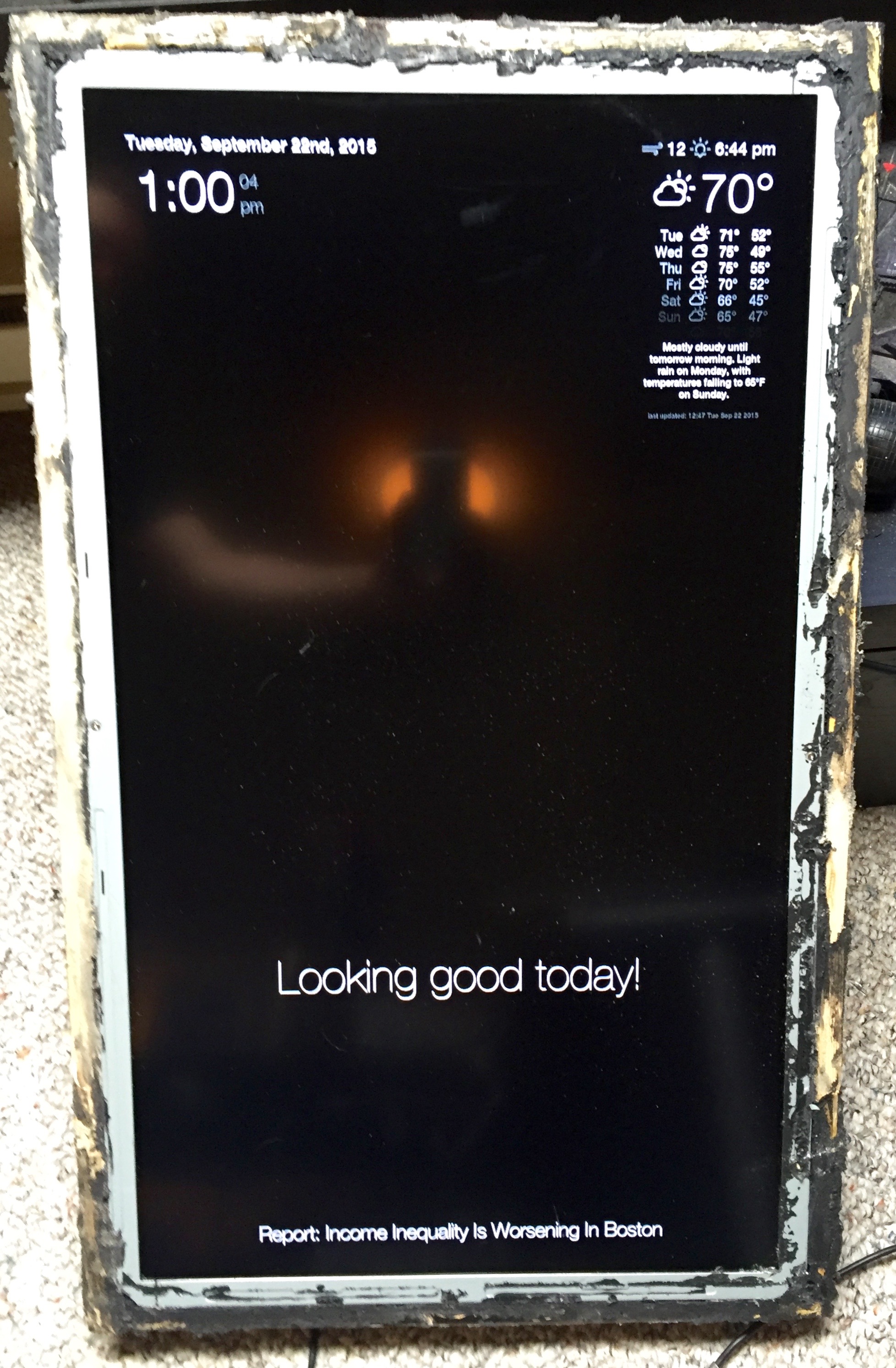 The screen and frame without the mirror, slightly damaged by the broken glass.