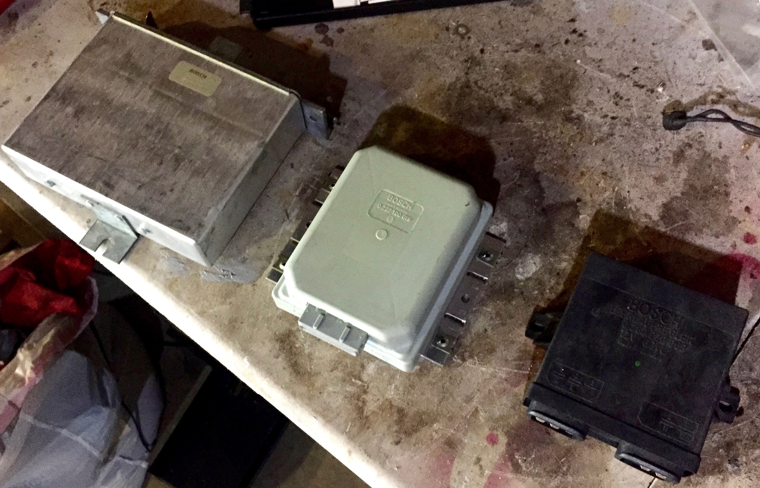 All three ECUs removed from the car: lambda (left, silver), ignition (center, grey) and idle (right, black).