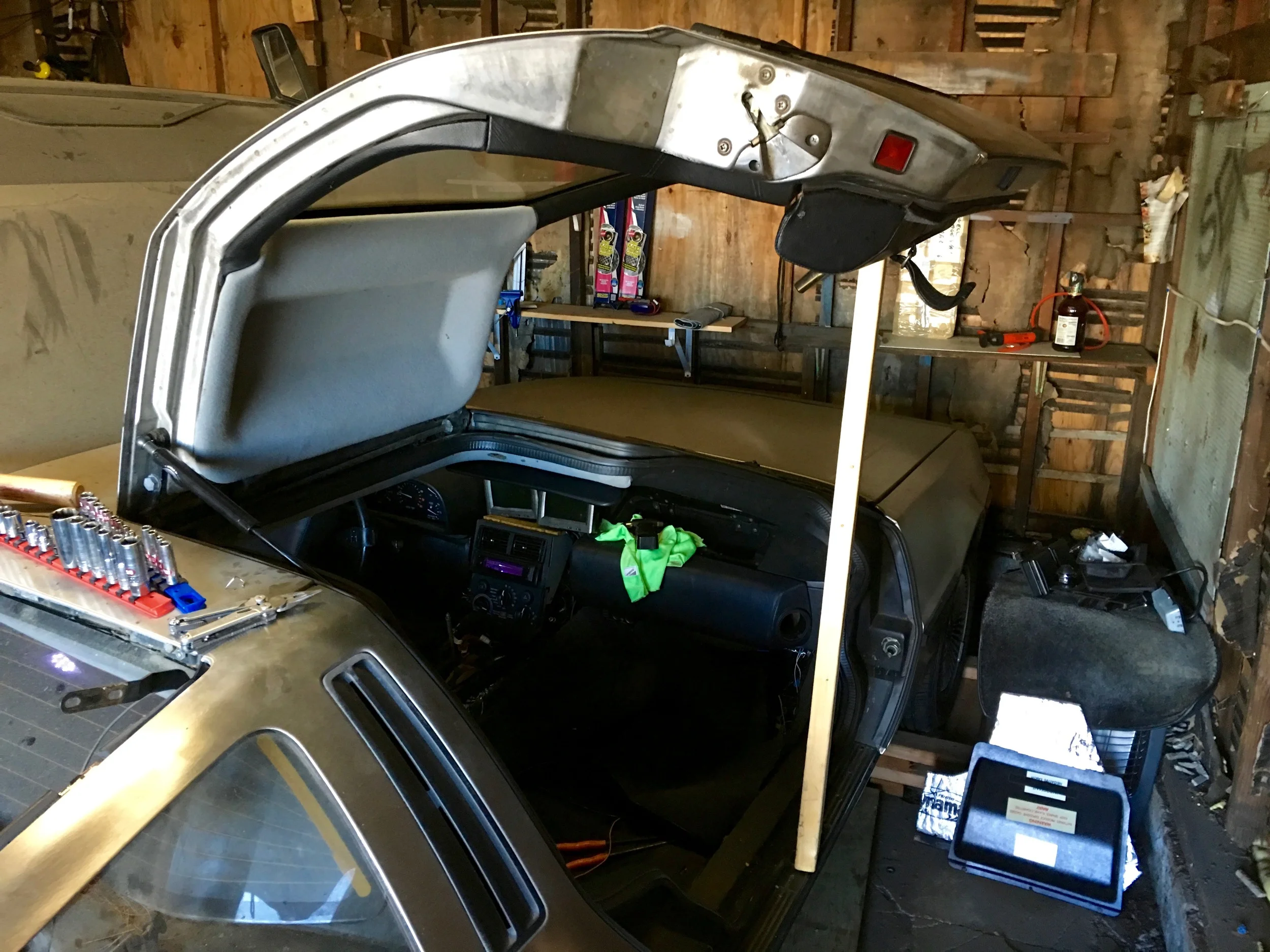 Using a 2x4 to prop the door open.