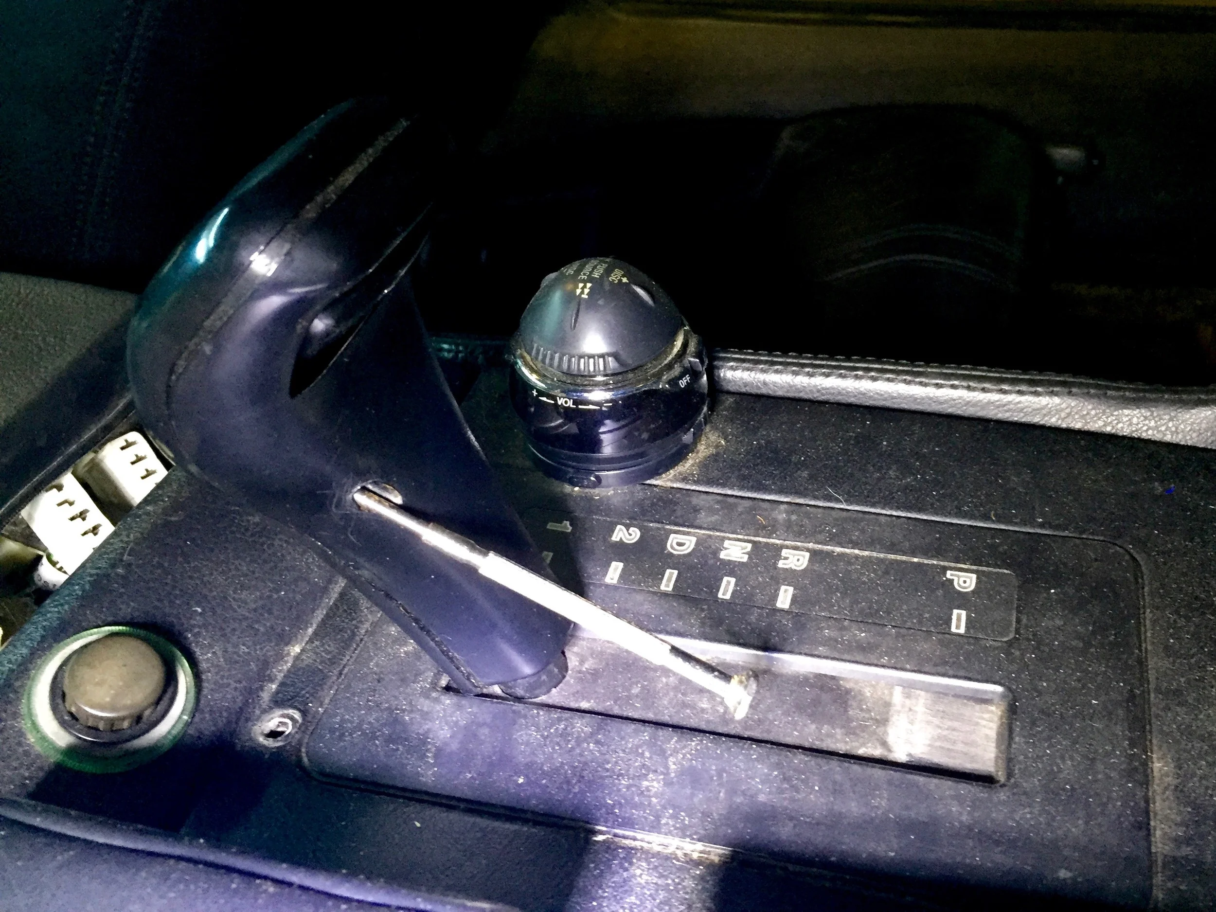 Using a small Philips screwdriver to remove the shifter handle.