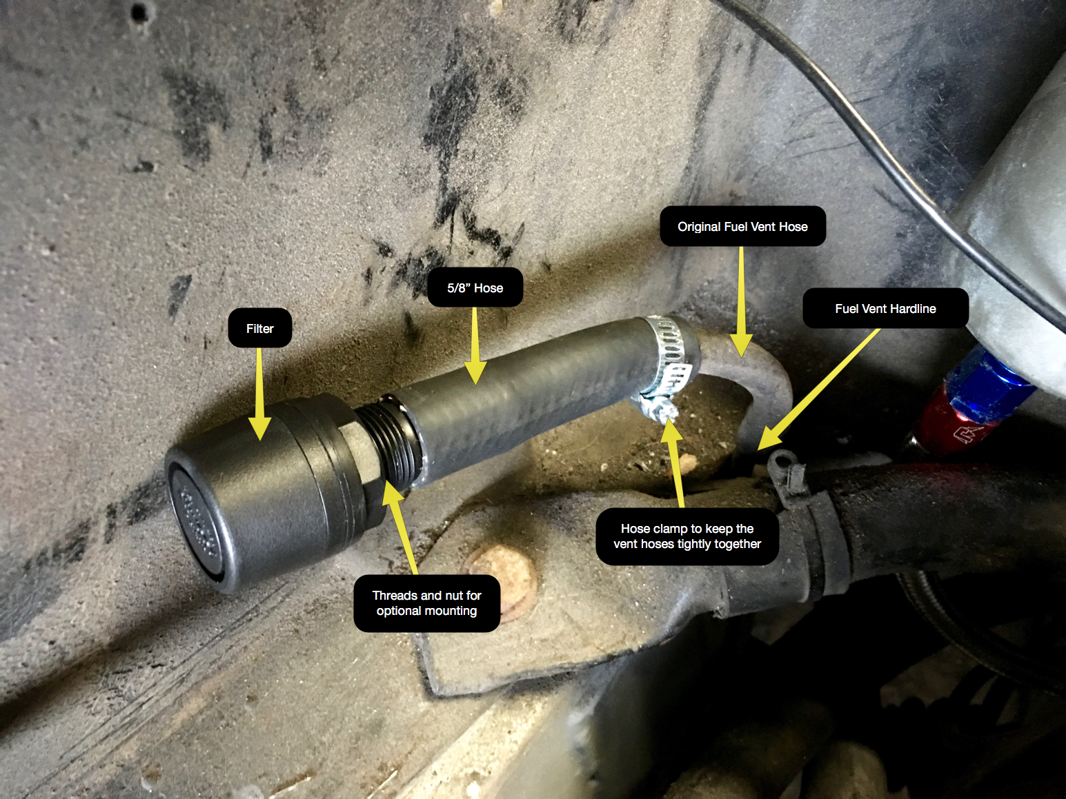 The fuel filter installed onto a 5/8" piece of hose, which in turn was slid over the original cut vent hose and secured with a hose clamp.