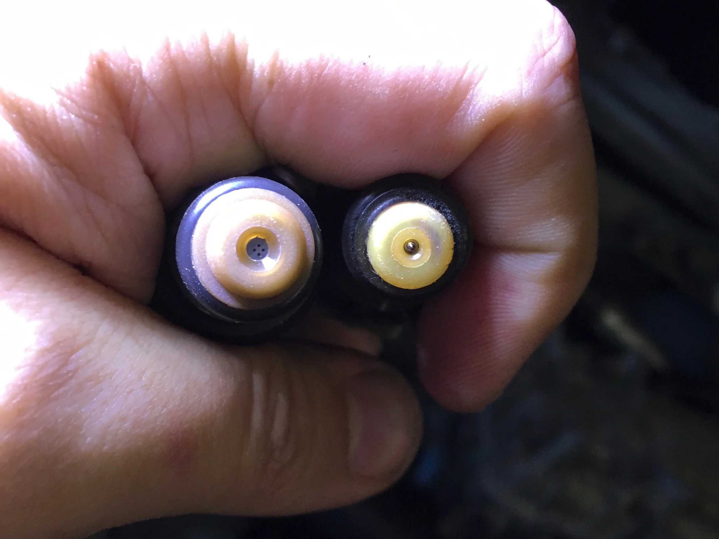 One of Josh's new injectors with four nozzles, and one of the originals with a pin that came with the original engine.