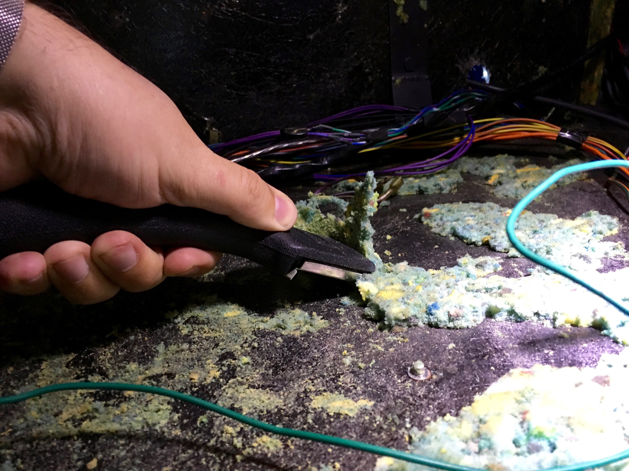 Removing the old stuck-on foam with a paint scraper.