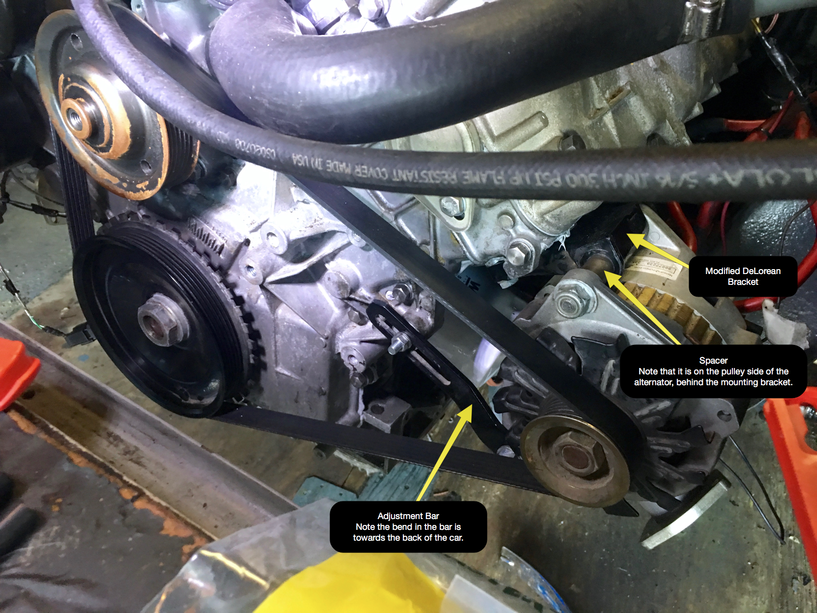The various parts of the correctly installed alternator, with the belt mounted and tightened.