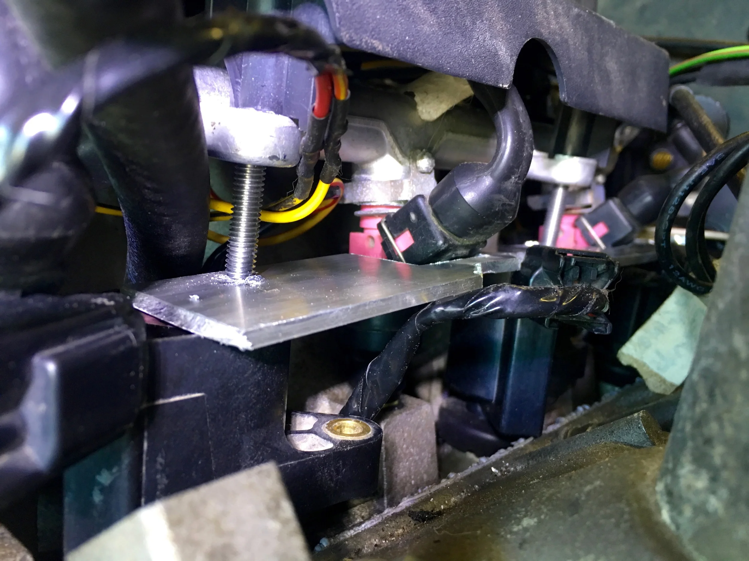 A close up of the passenger side bracket and how it is held down with the bolt.