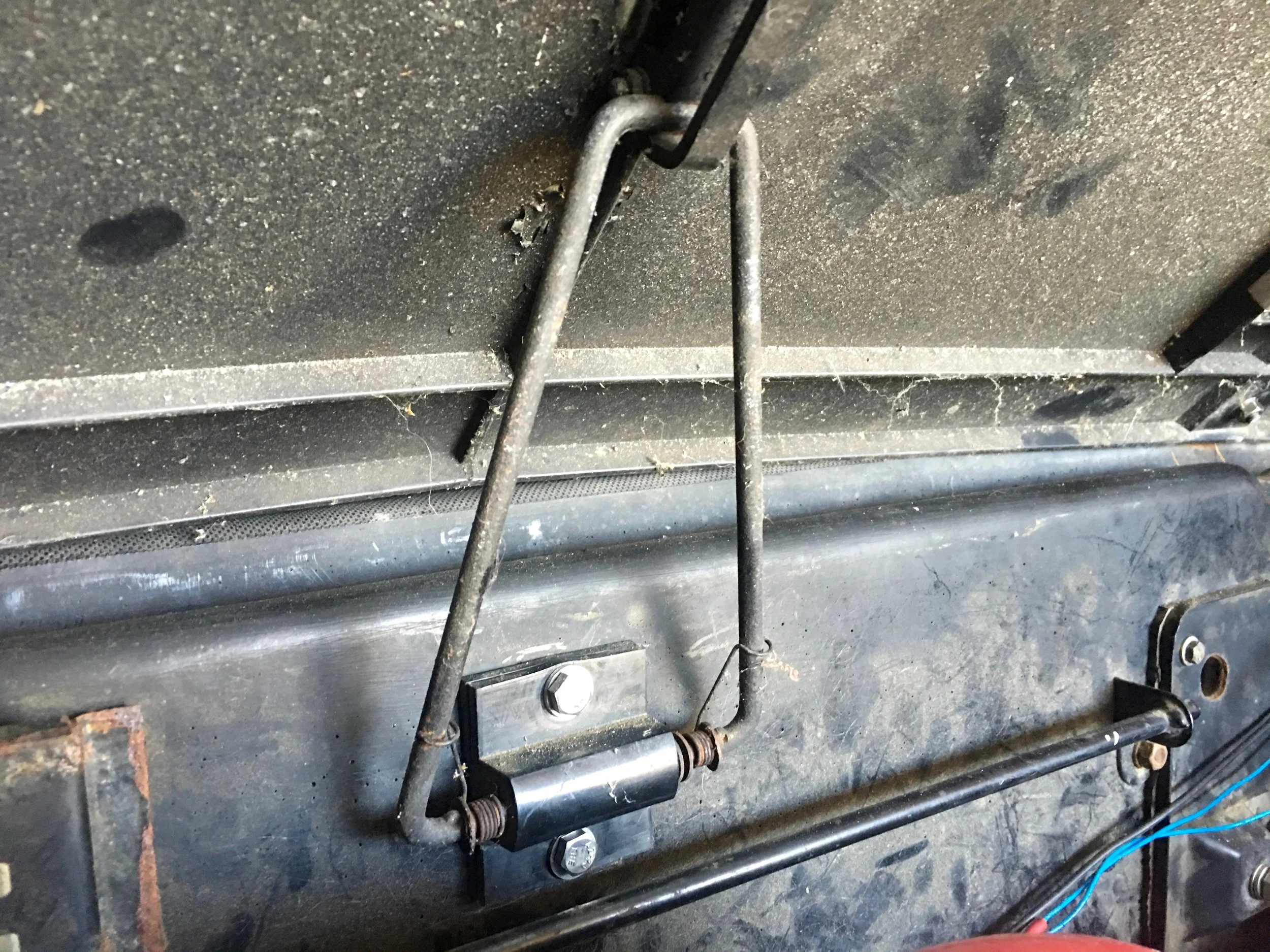 The hold-up bracket mounted to the engine bay.