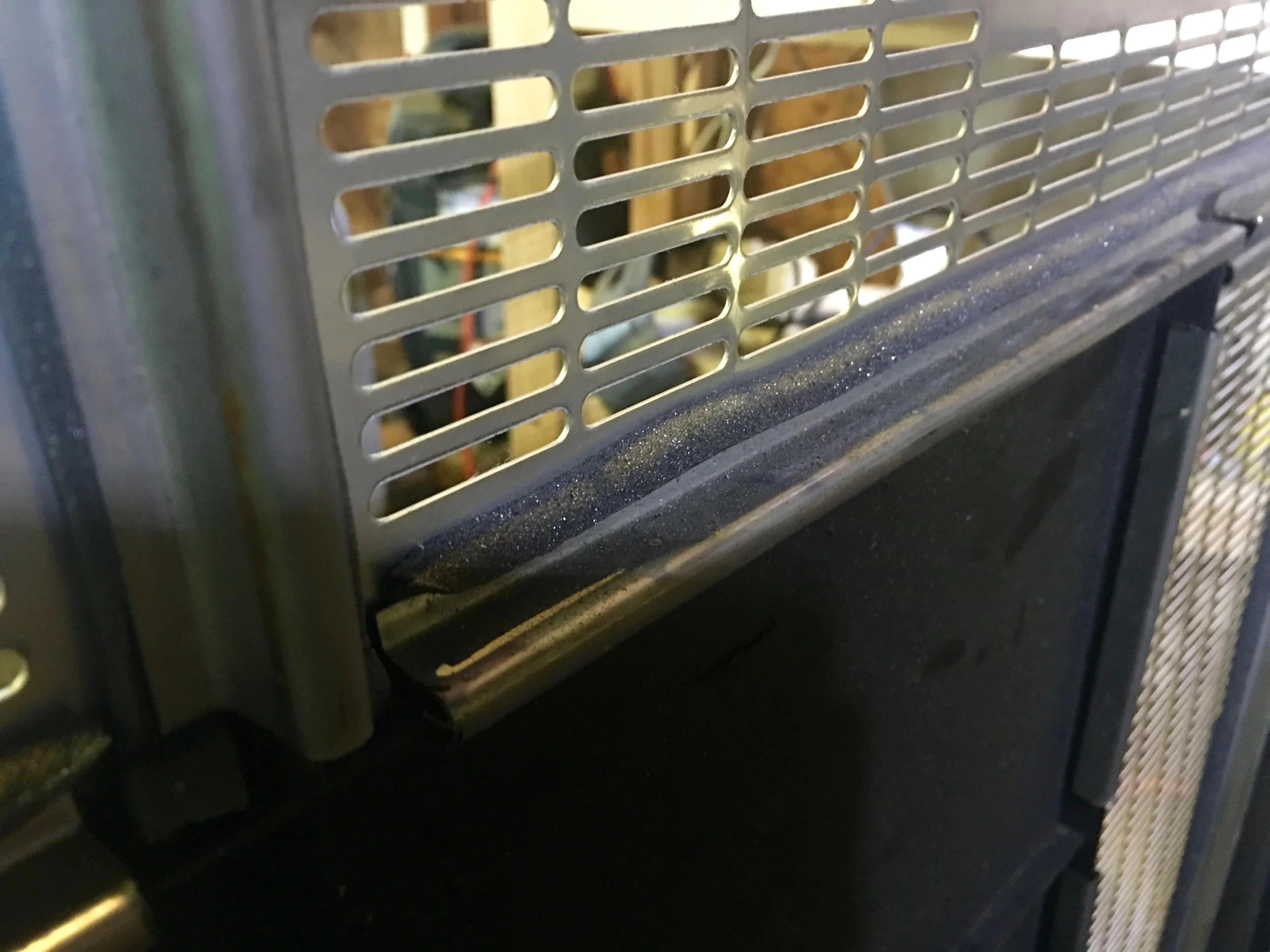 The stainless steel retaining strips on top of the some foam to keep the strips from rattling.