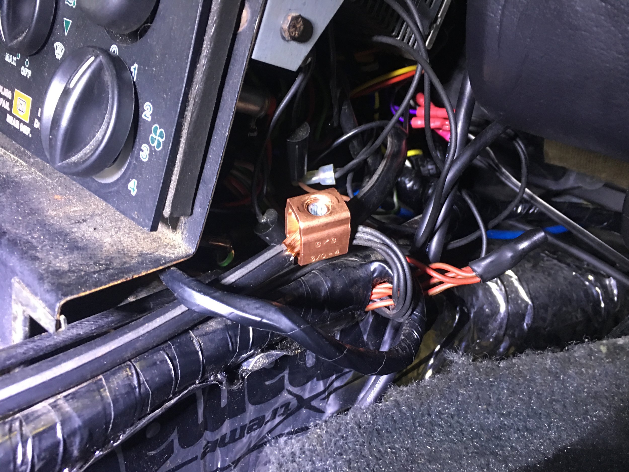 The ground bundle next to the climate controls, now tied into the ground bus via a lug.