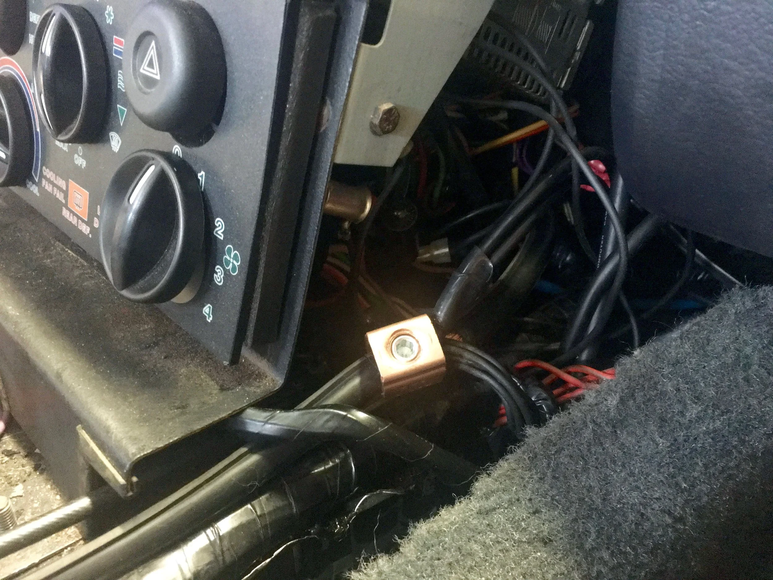 The 10 gauge wires now connected to the lug and ground bundle on the bus on the passenger side of the climate controls.