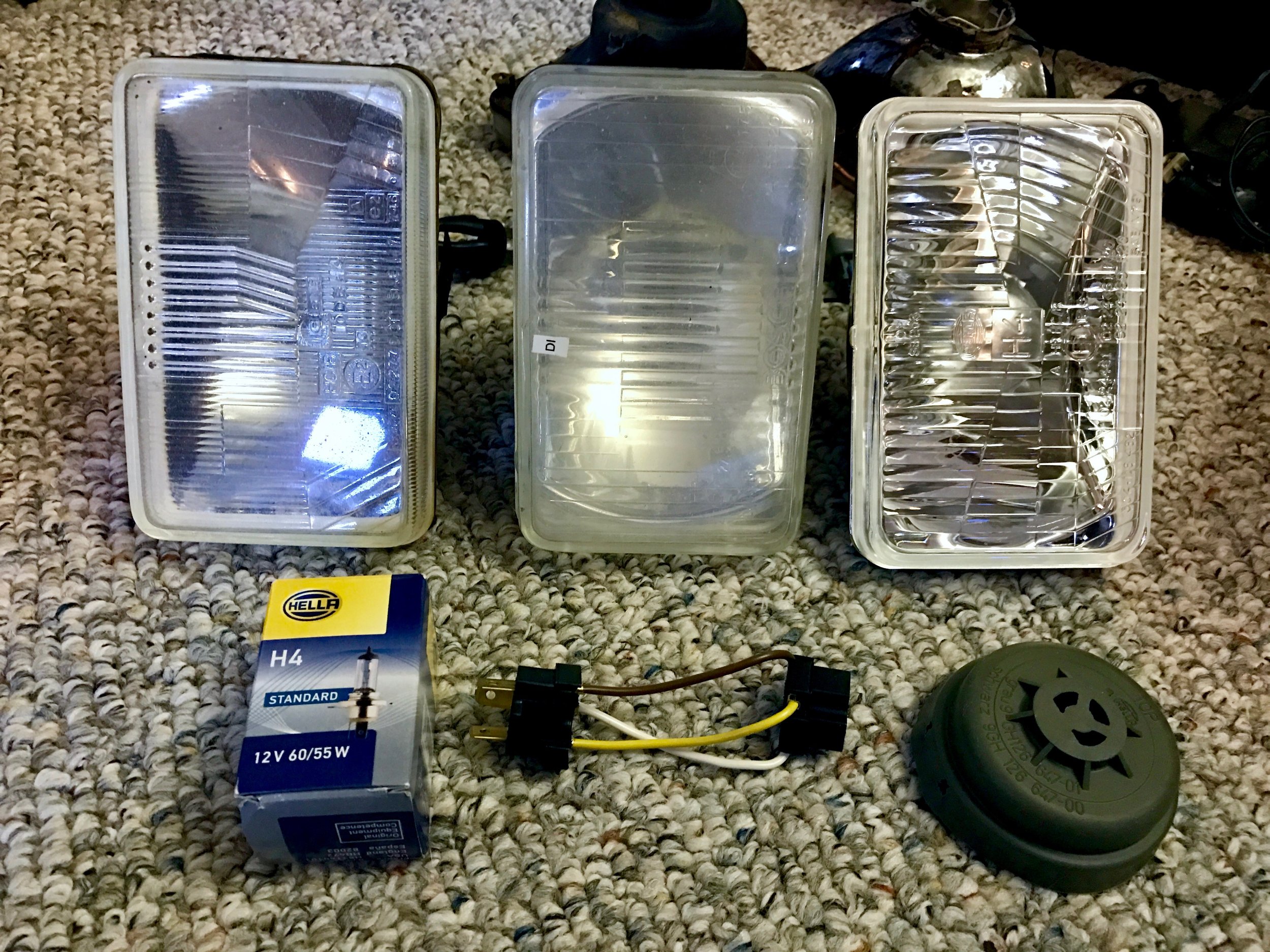 The old fogged (due to micro-scratches) lenses (left and center) and the new Hela lens (right). The sense also included an H4 bulb (bottom left), an adaptor pigtail (bottom center) and a rubber plug that I didn't install.