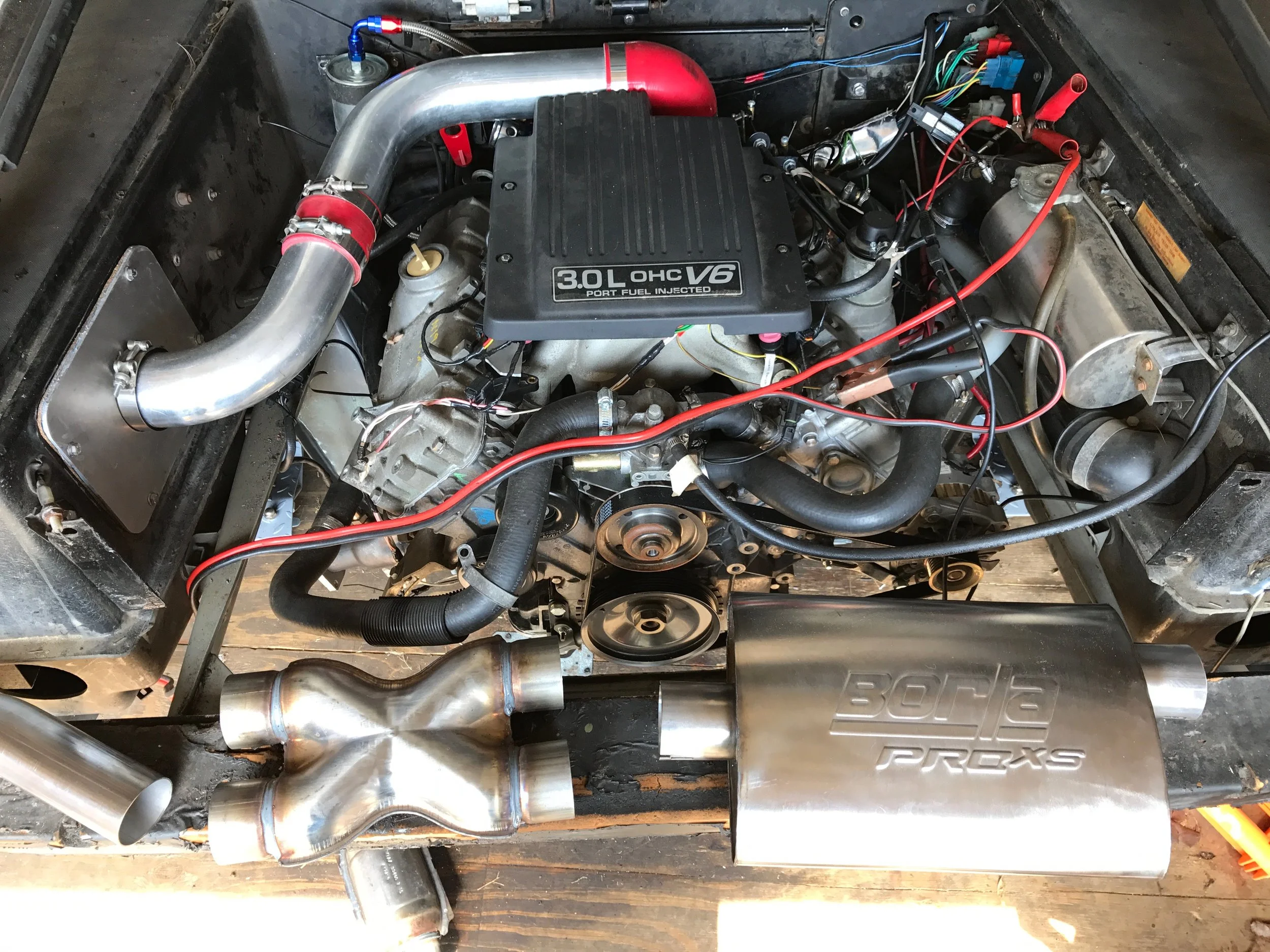 The "X" pipe and muffler intended for one side of the engine. which in the end wouldn't fit. The cat can be seen on the ground.