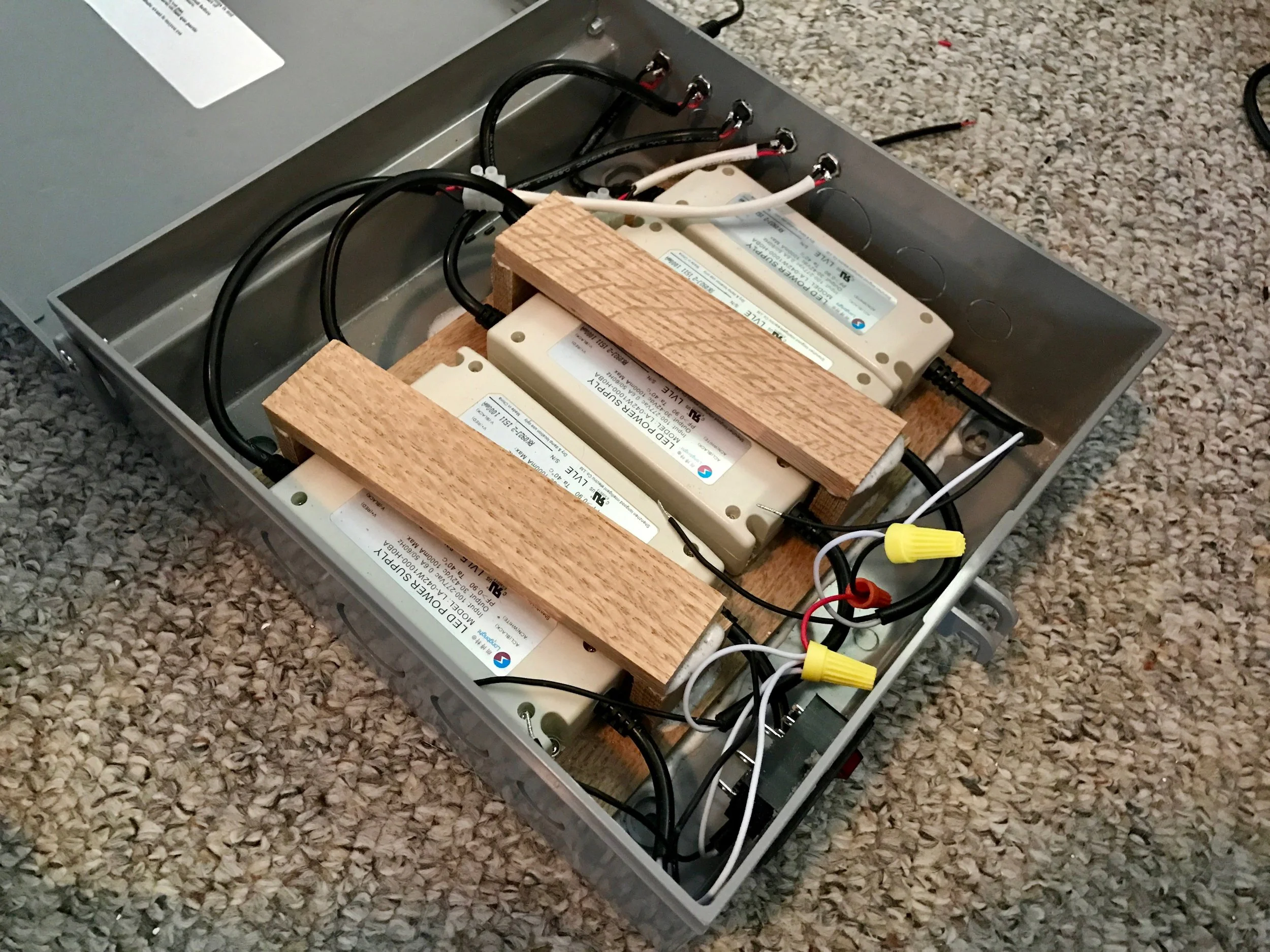 The power supplies installed in the box, screwed into a pair of wooden strips glued to the back. The two pipes of wood on top are to mount the electronics.