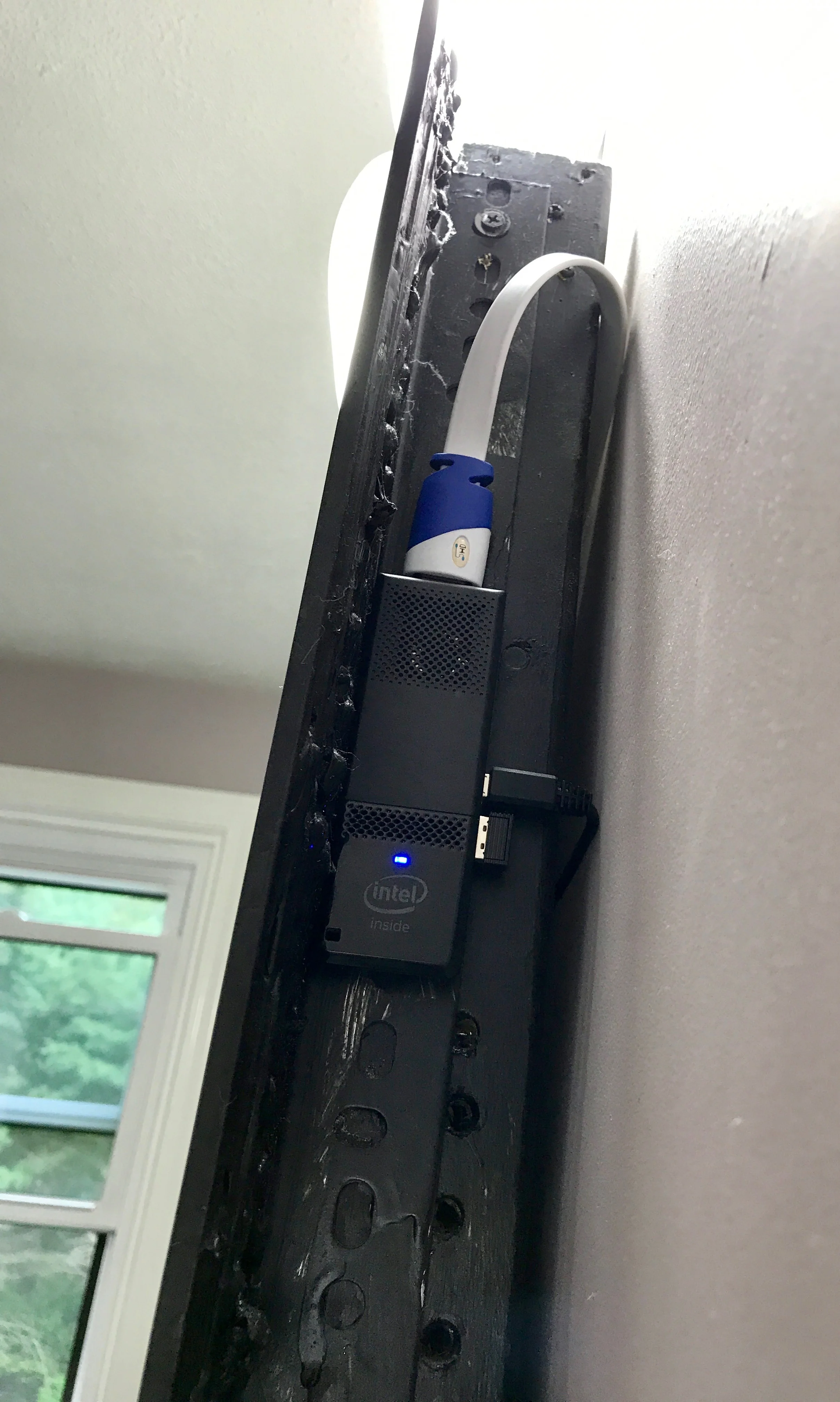 The Compute Stick mounted on the outside of the mirror, which almost doubled the wifi speed and improved cooling.